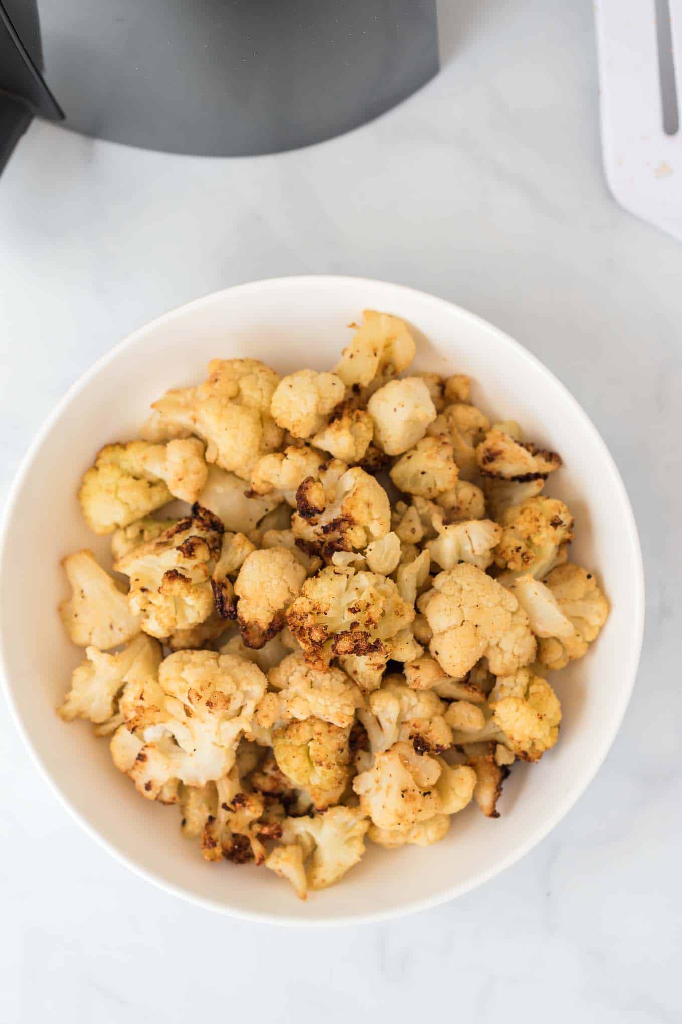 cooked cauliflower in a white bowl