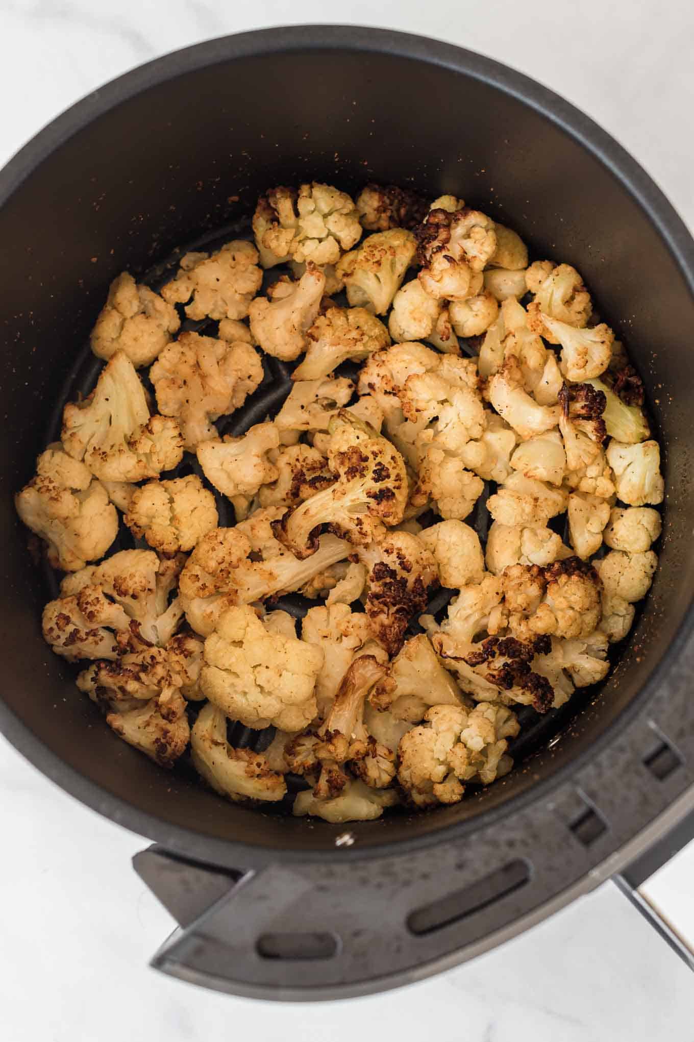 air fried frozen cauliflower in the air fryer basket