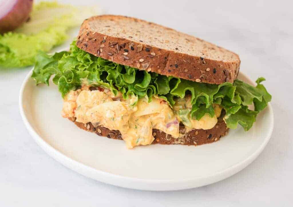 healthy egg salad sandwich with lettuce on top