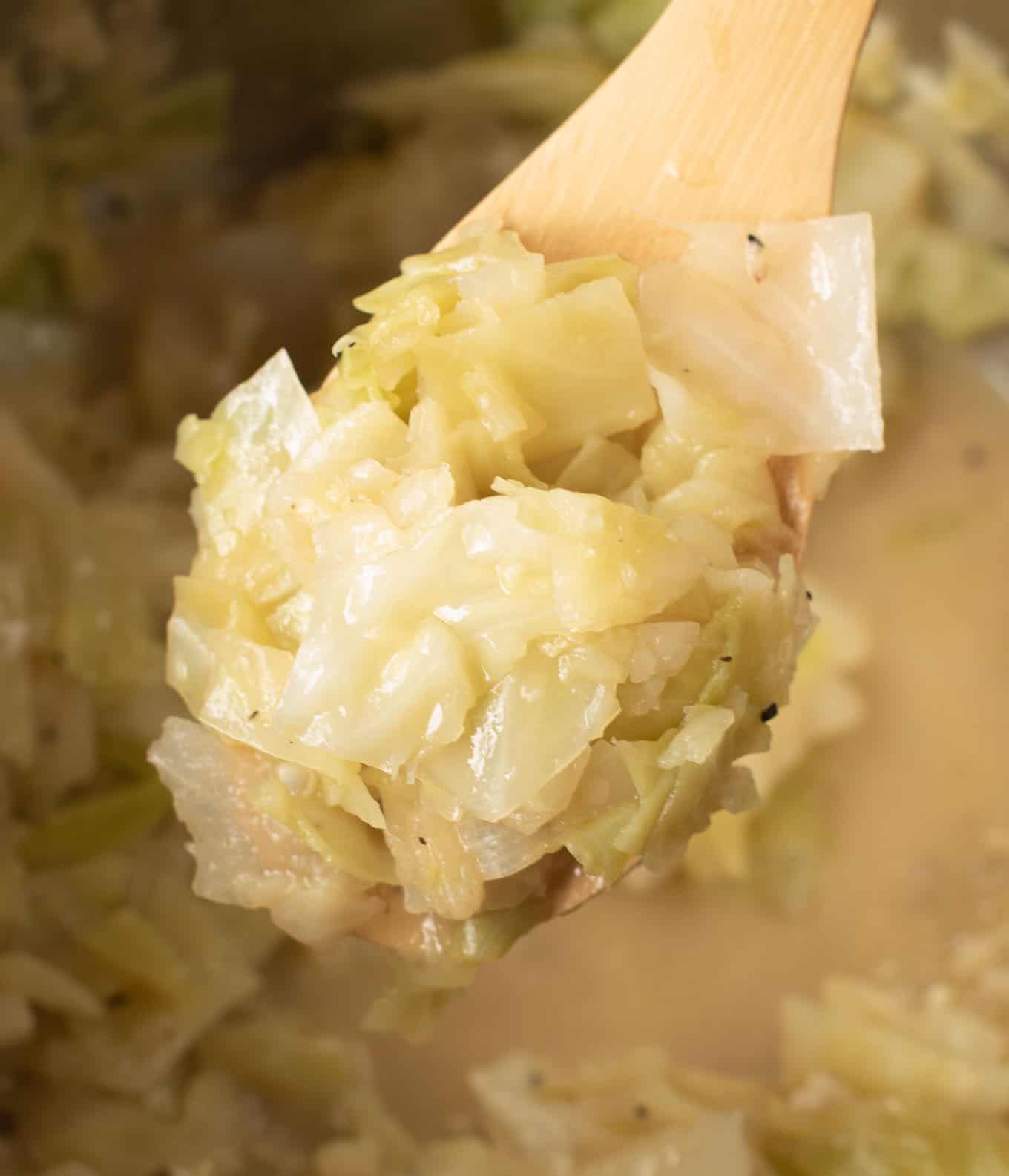 a spoon taking a scoop of buttered cabbage from the instant pot