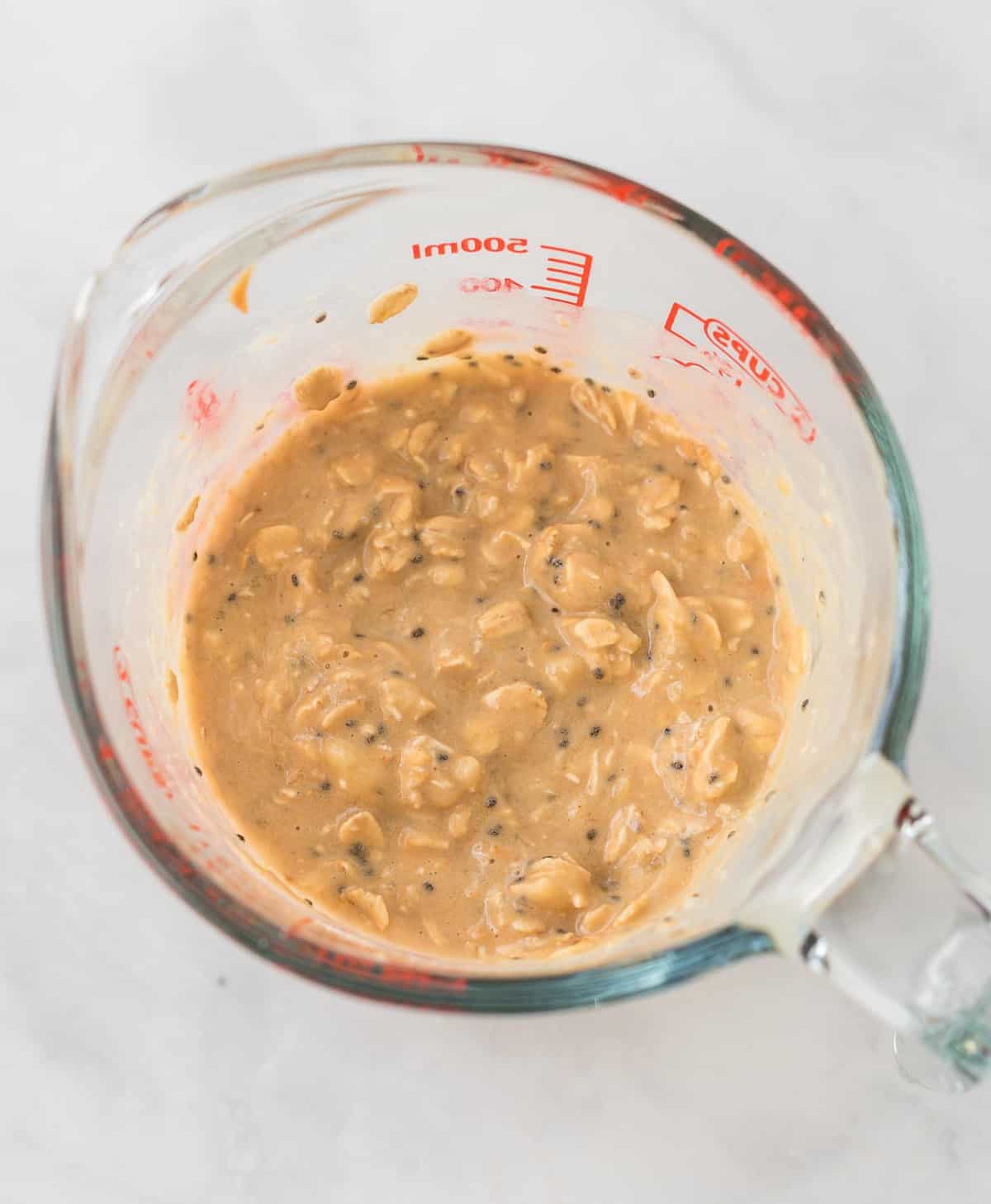 oats mixed up in a glass measuring cup