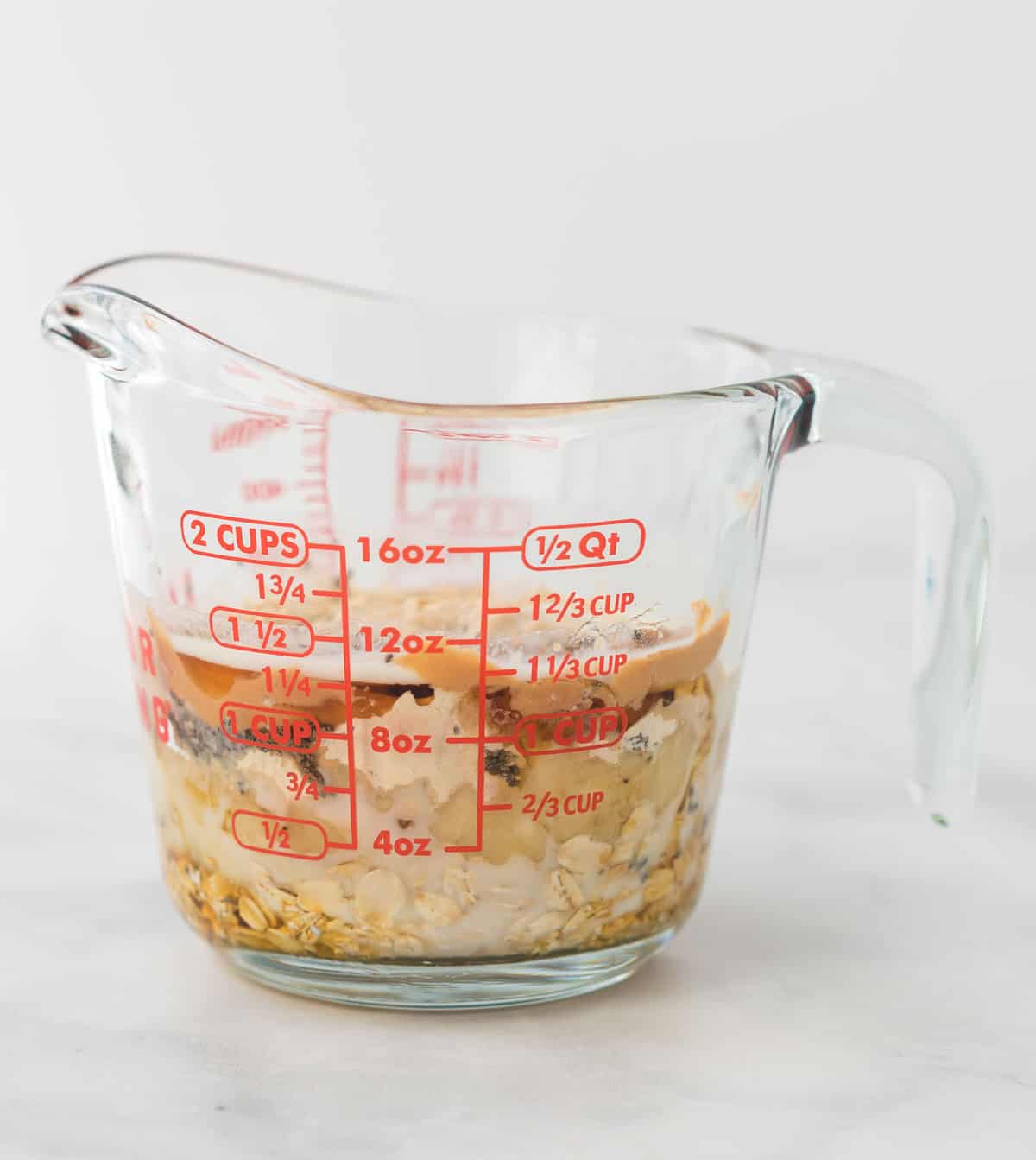 overnight oats in a glass measuring cup