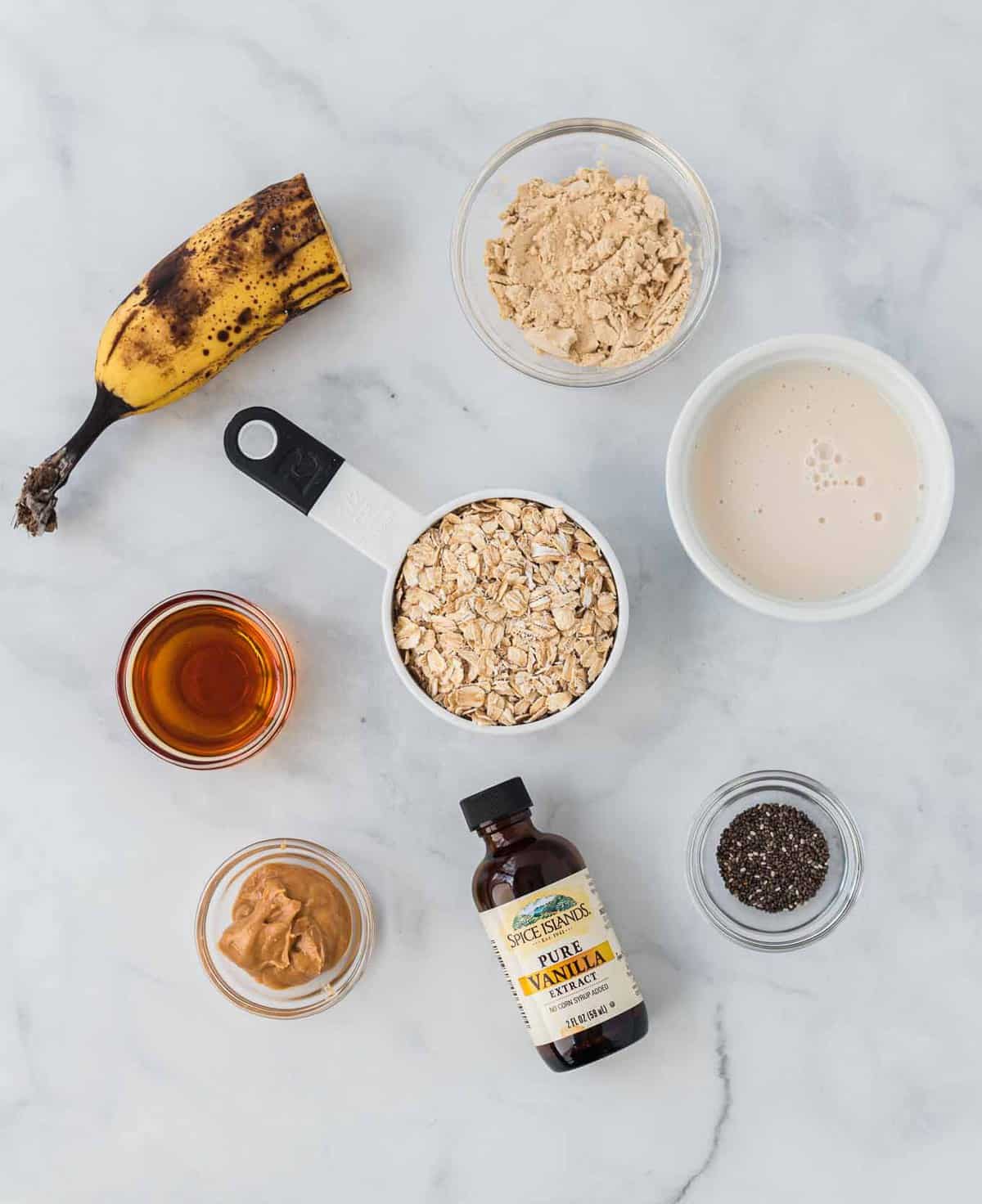 ingredients for overnight oats laid out on a marble background