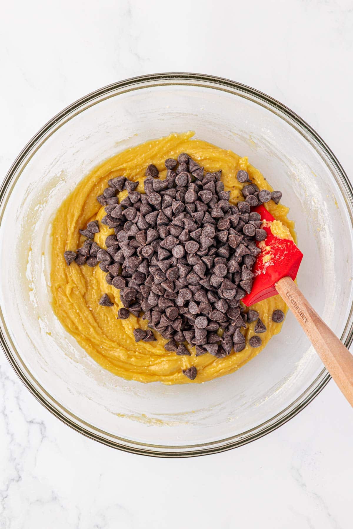 adding the chocolate chips to the cookie batter
