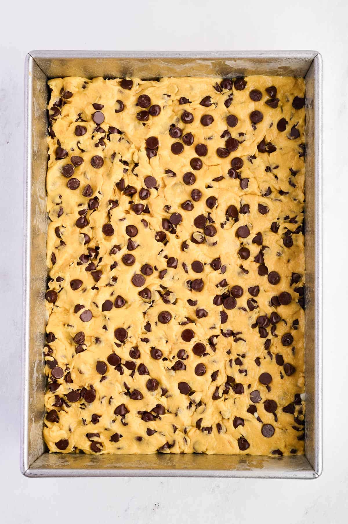 cake mix cookie bar batter pressed into the baking dish