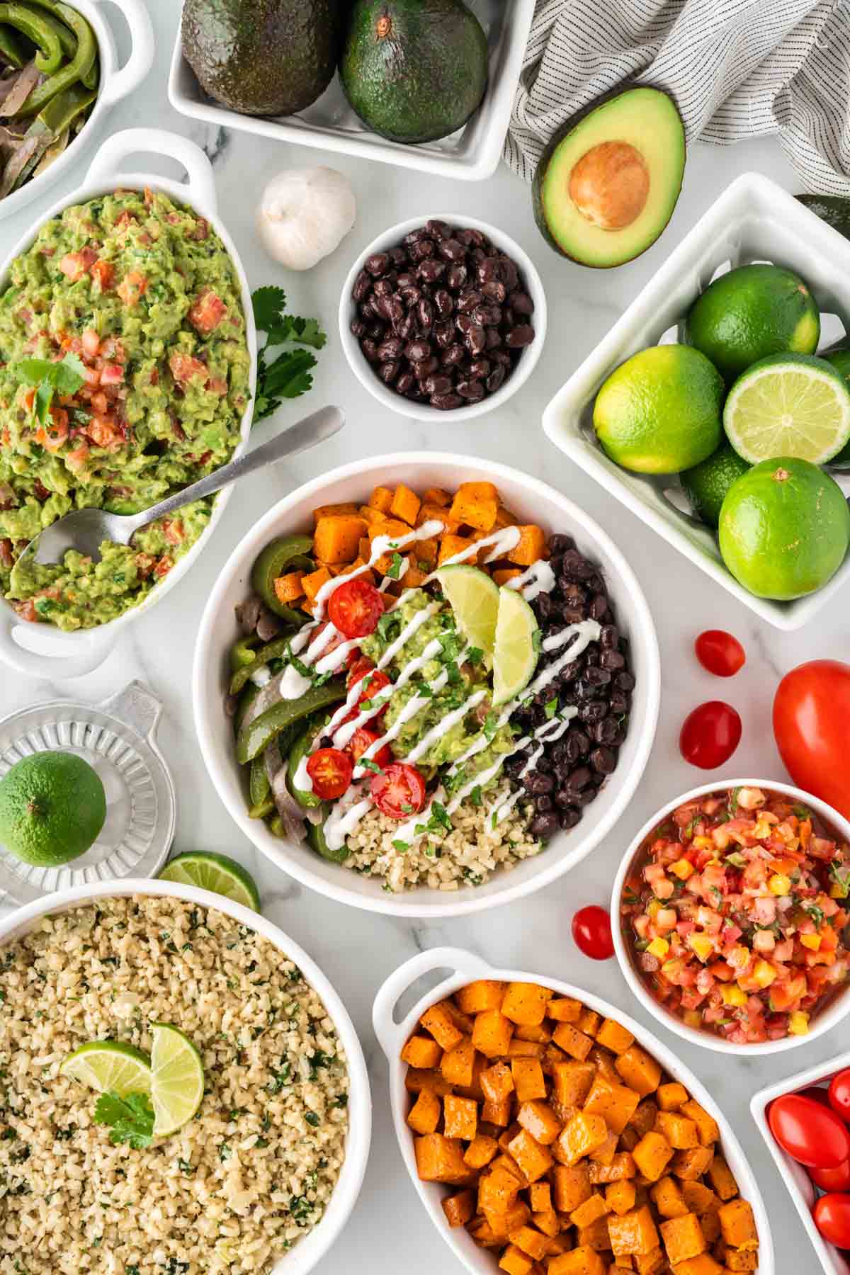 cauliflower rice burrito bowl with black beans, fajita veggies, sweet potatoes, and guacamole