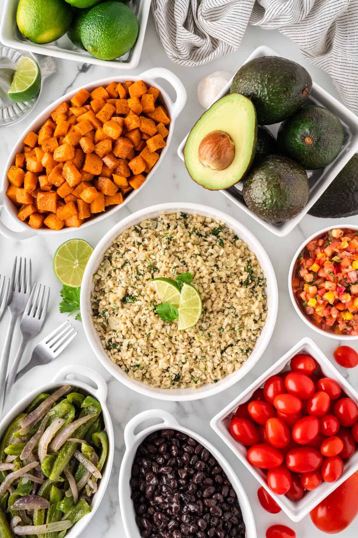 cauliflower rice burrito bowl components in separate bowls