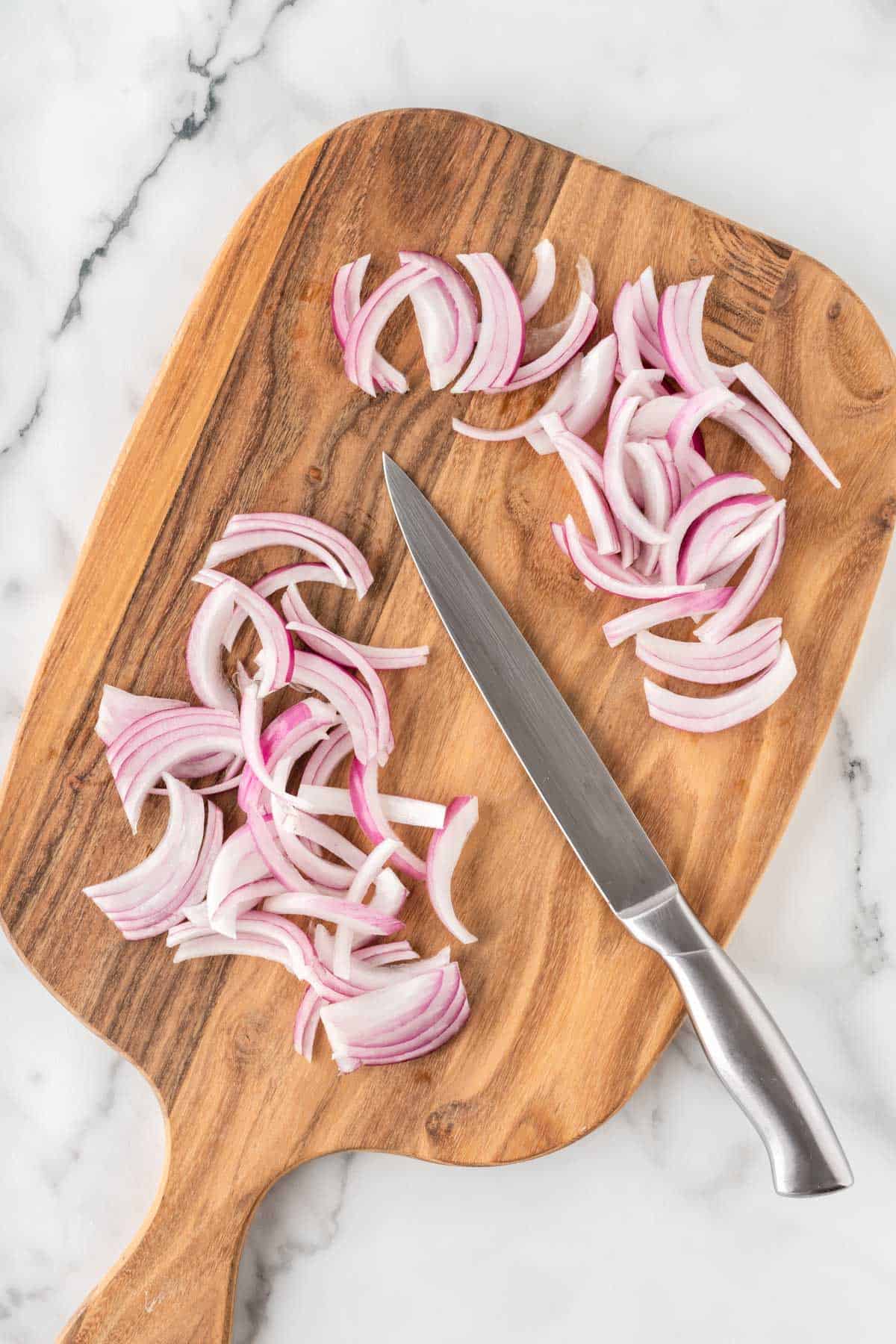 cutting red onion into slices