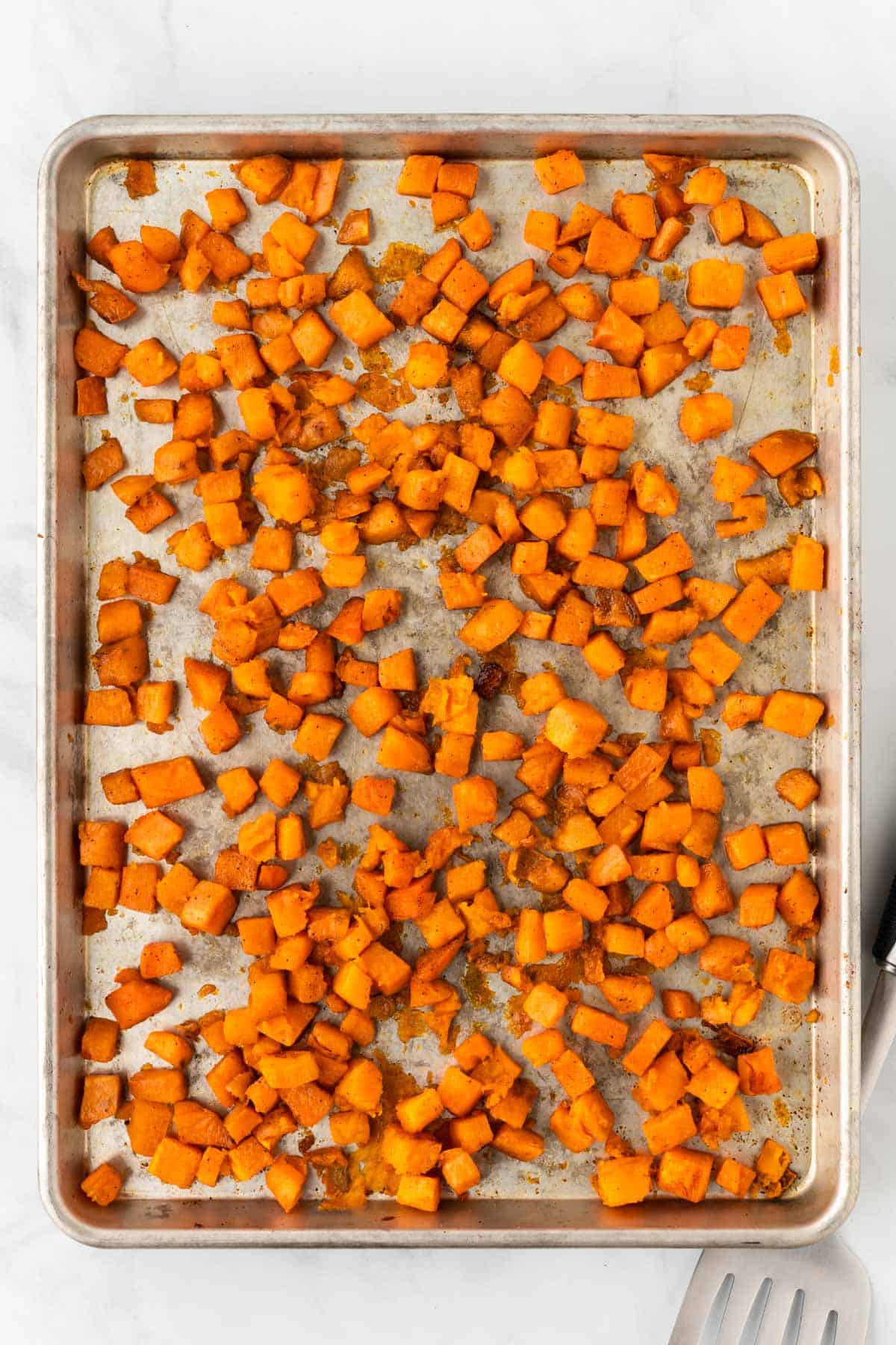 roasted sweet potato cubes on a baking sheet