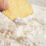 dipping a chip into sour cream dip