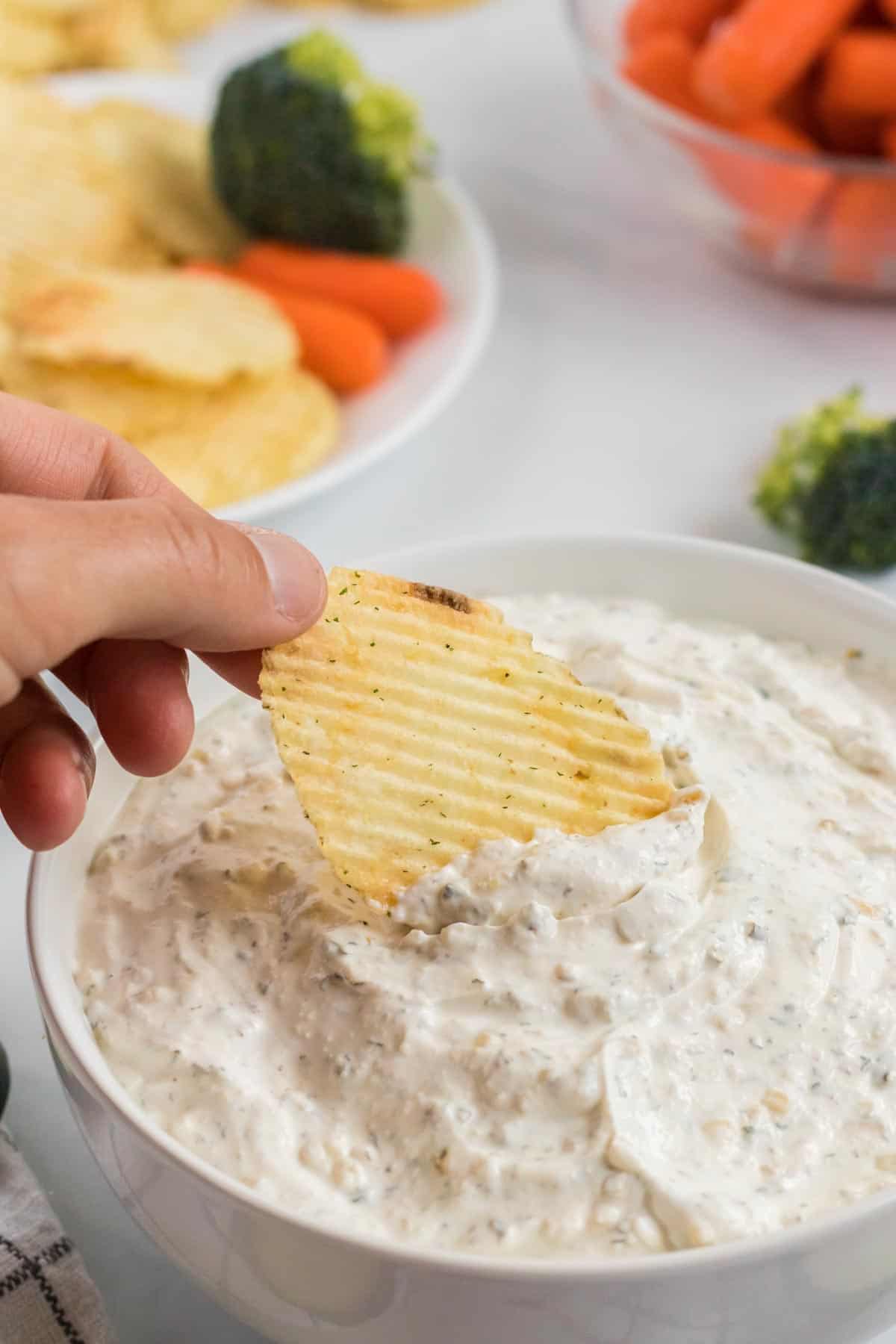 chip being dipped into a chip dip