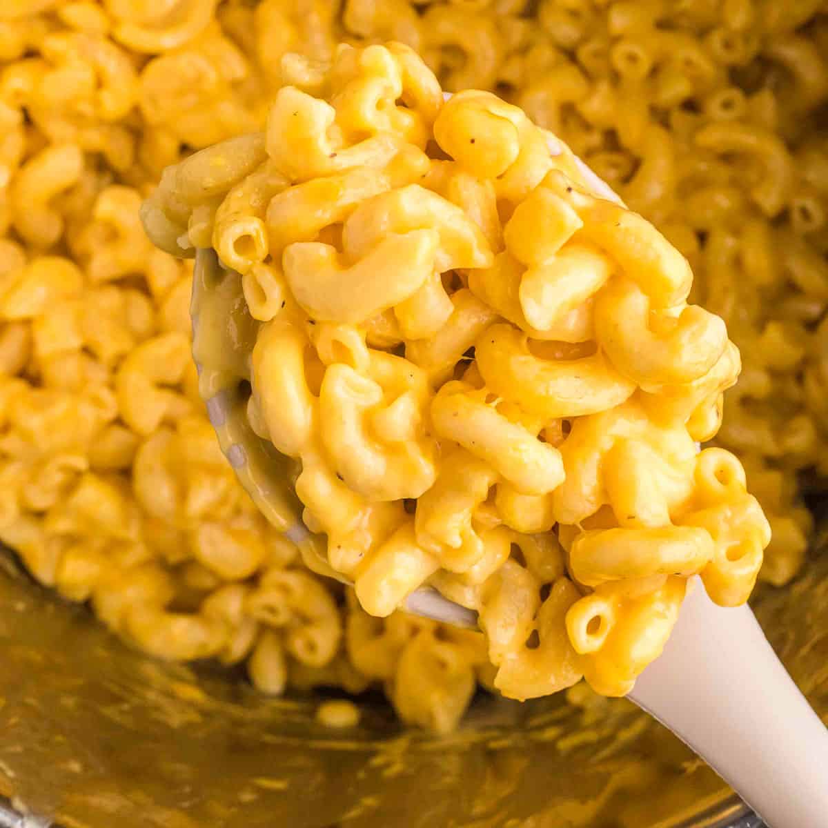 spoon taking a scoop of instant pot mac and cheese