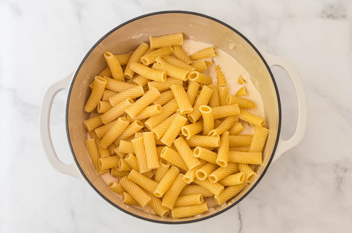 cooked rigatoni noodles in a white dutch oven