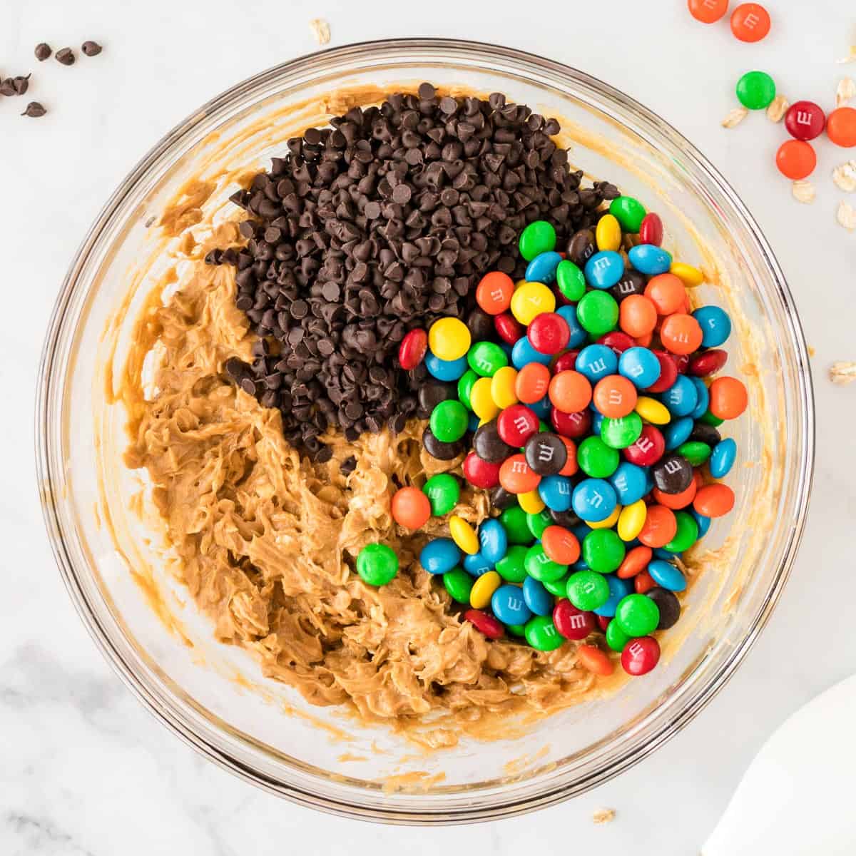adding mini chocolate chips and m & m's to the cookie batter