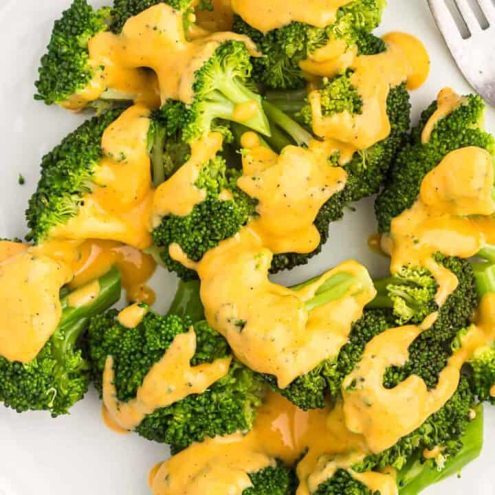 cheese sauce drizzled over steamed broccoli