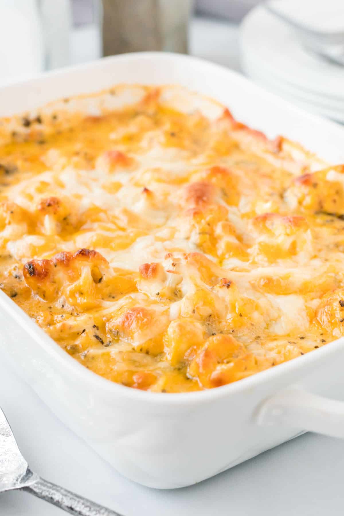 cheesy cauliflower casserole in a white baking dish