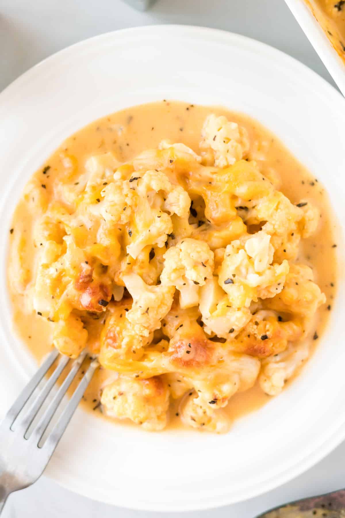 cheesy cauliflower on a white plate