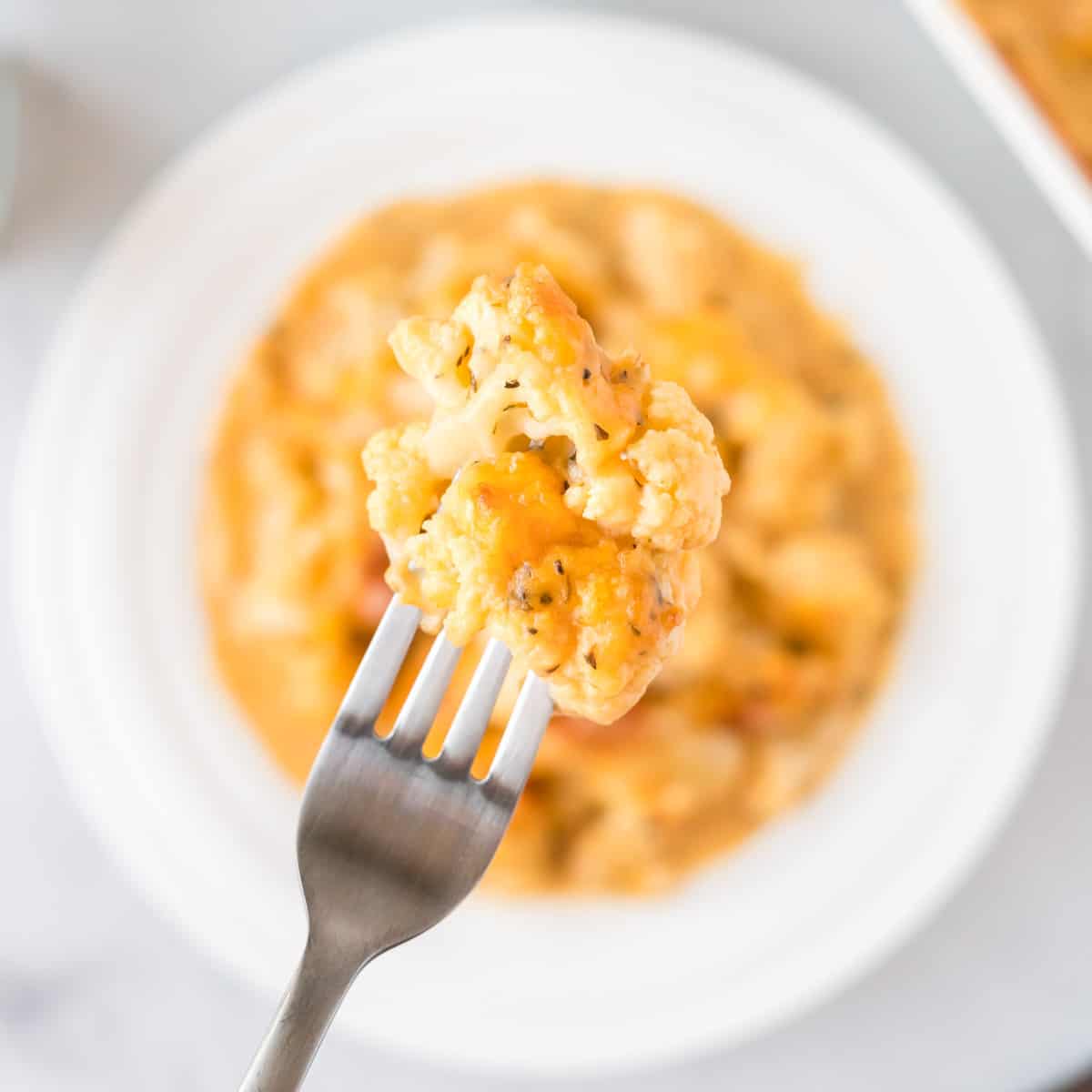 fork with a piece of cheesy cauliflower