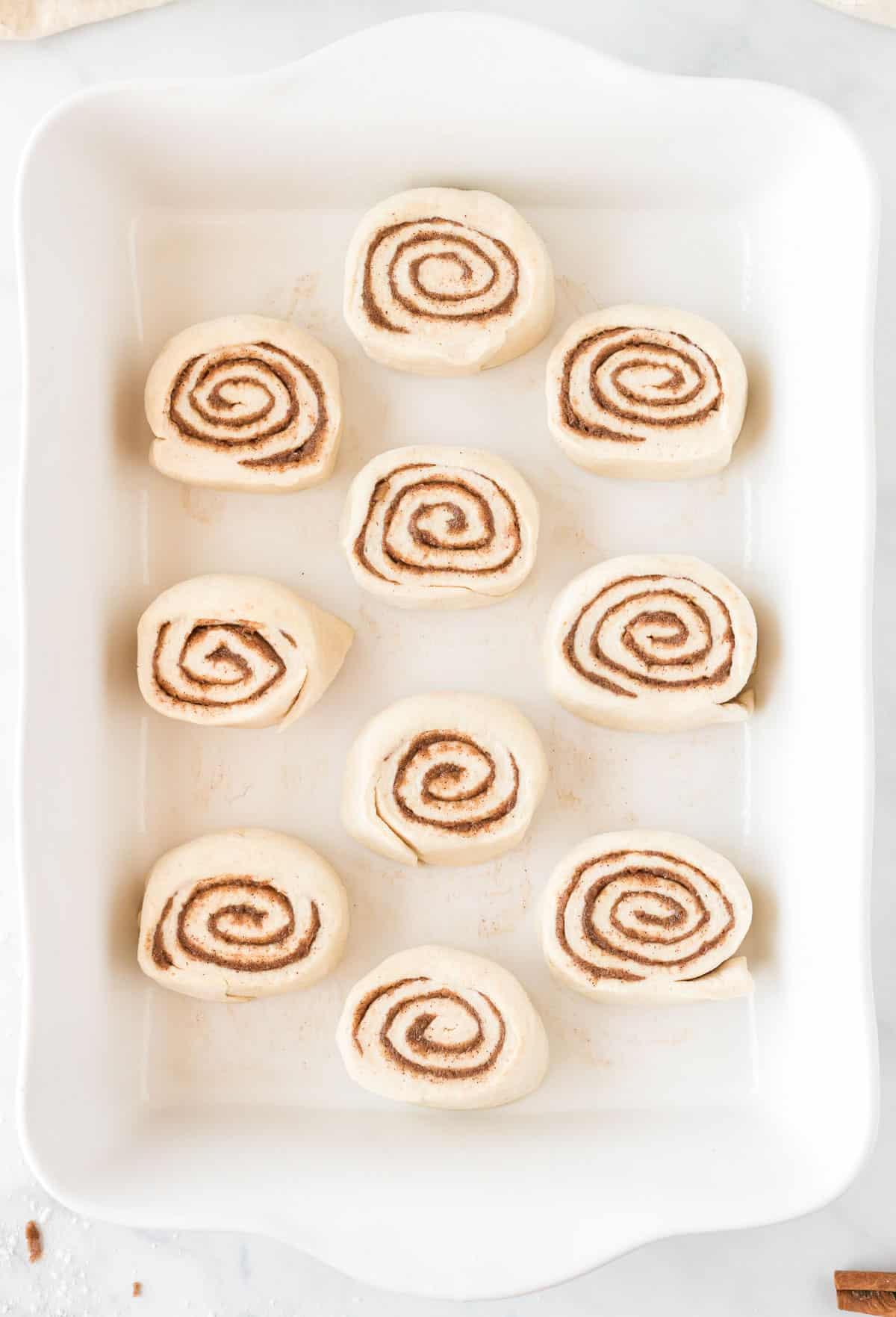 cinnamon rolls raw in the baking dish