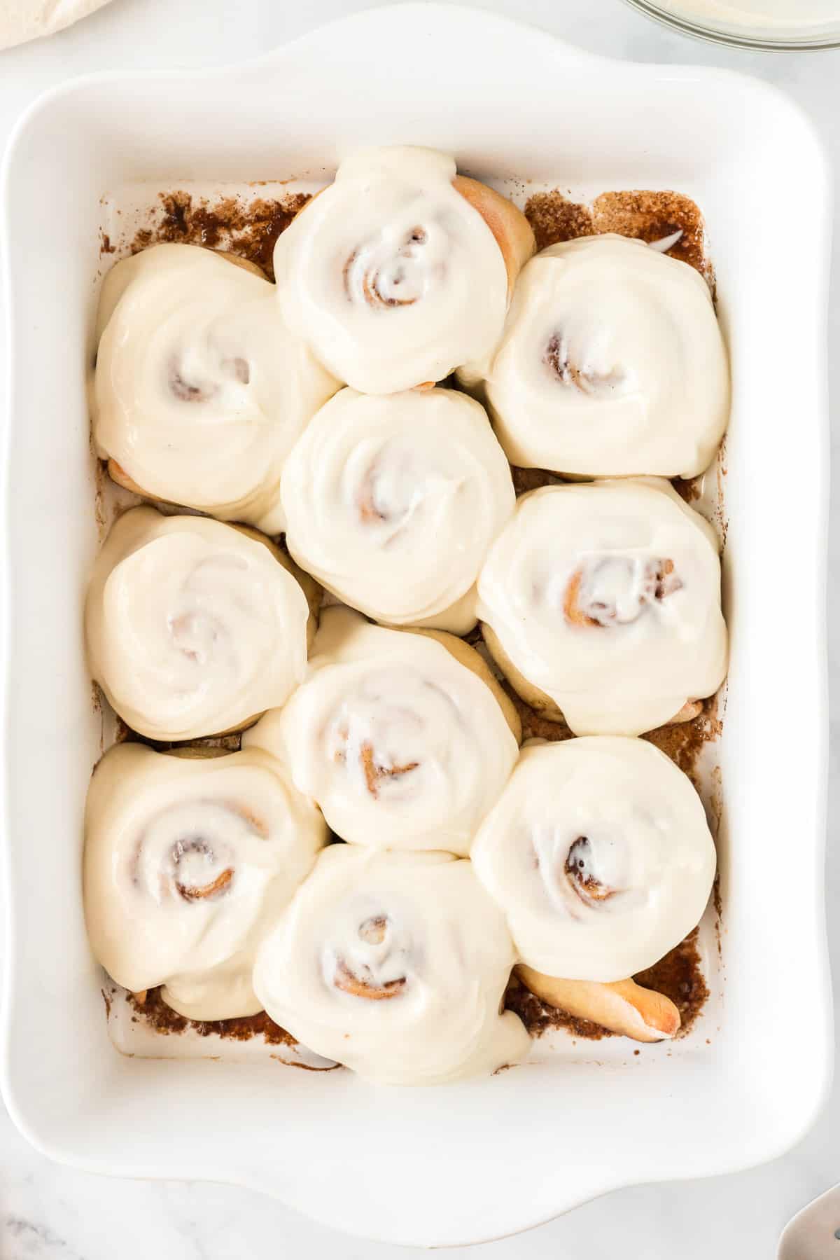 cinnamon rolls spread with cream cheese icing