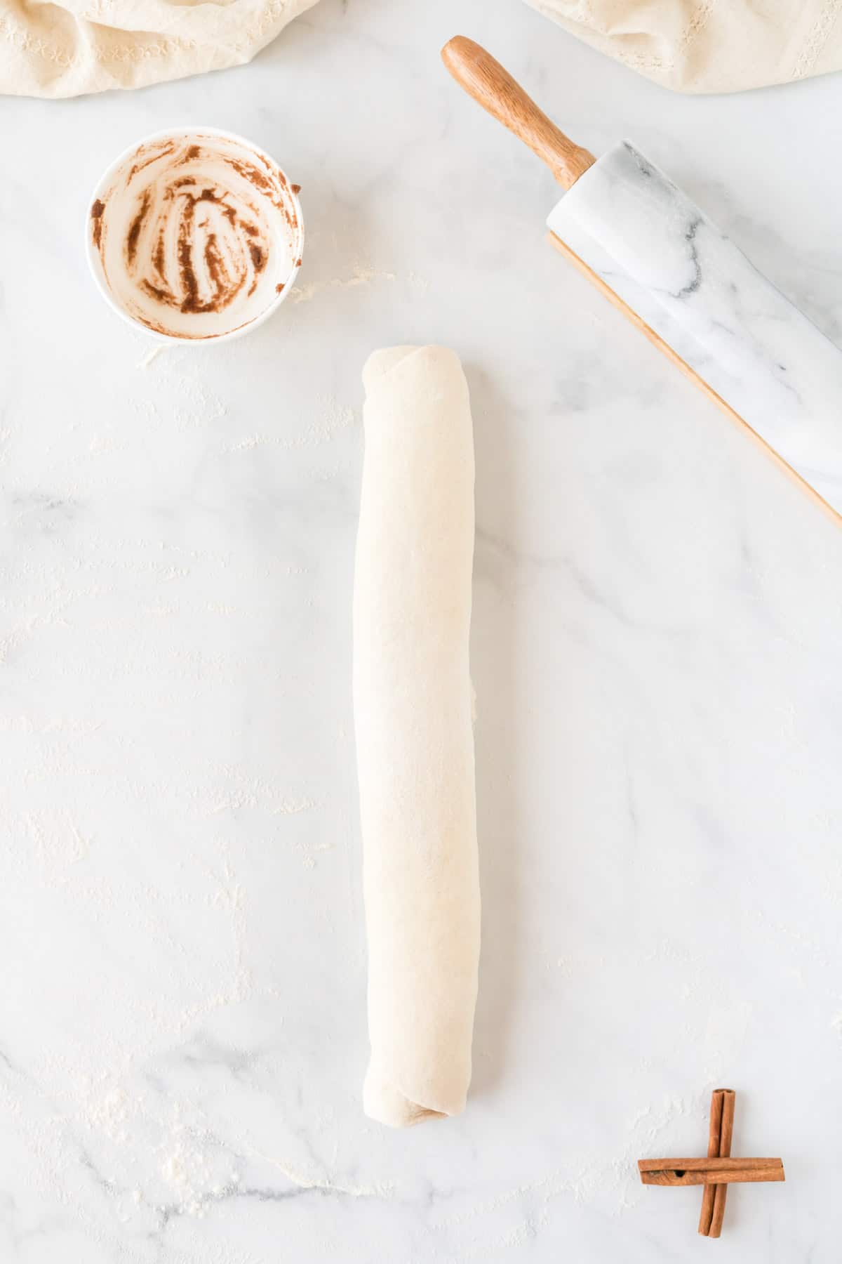 cinnamon roll dough rolled into a log shape