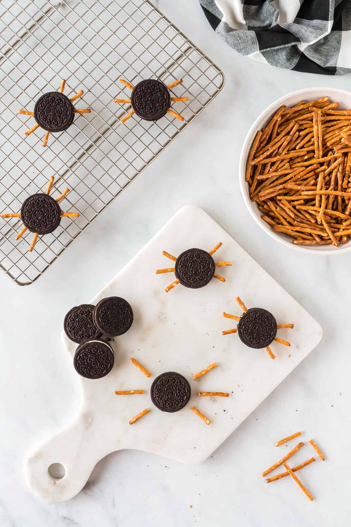 placing the pretzels into the oreo cookie