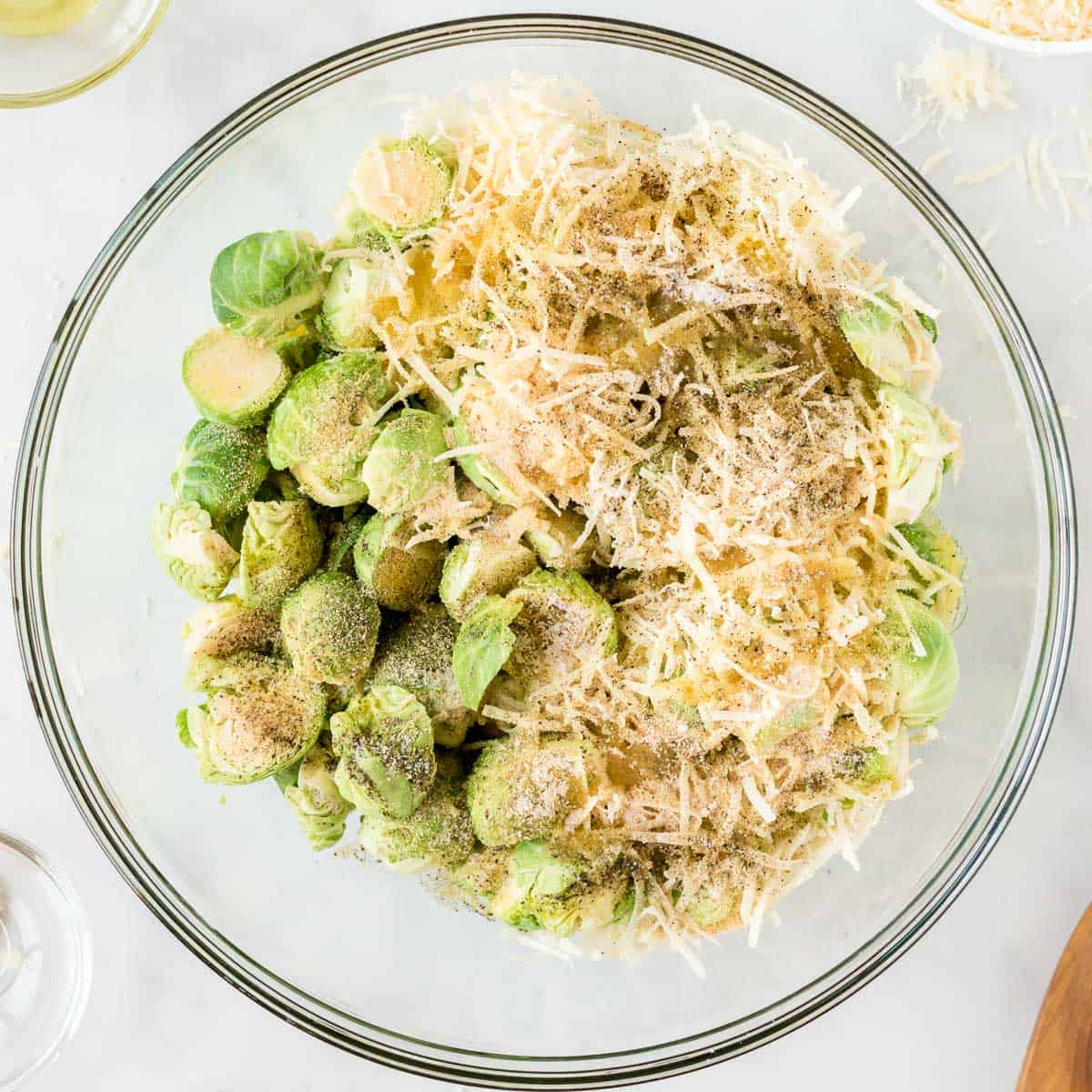 adding the cheese and spices to the brussels sprouts