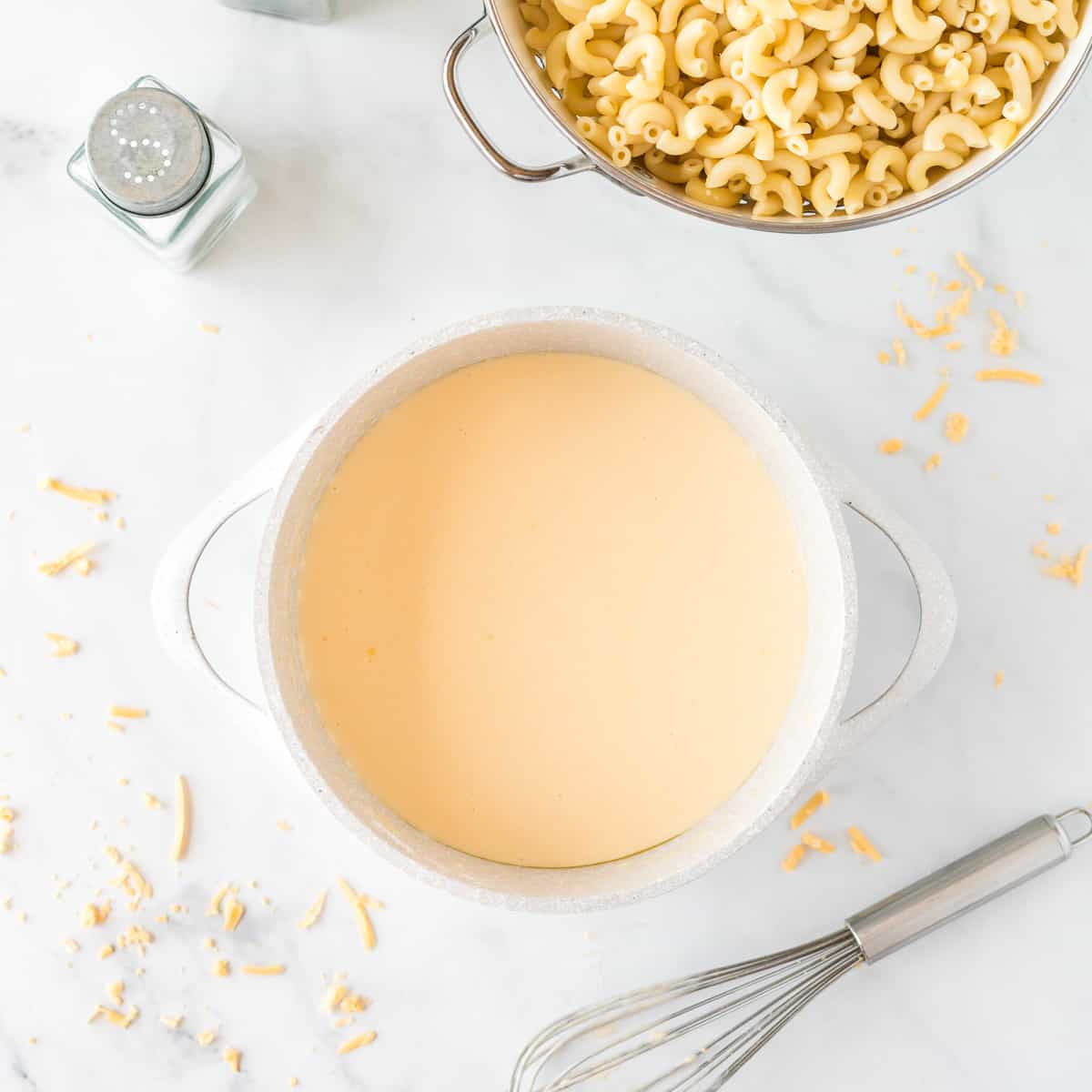 cheese sauce next to the macaroni noodles