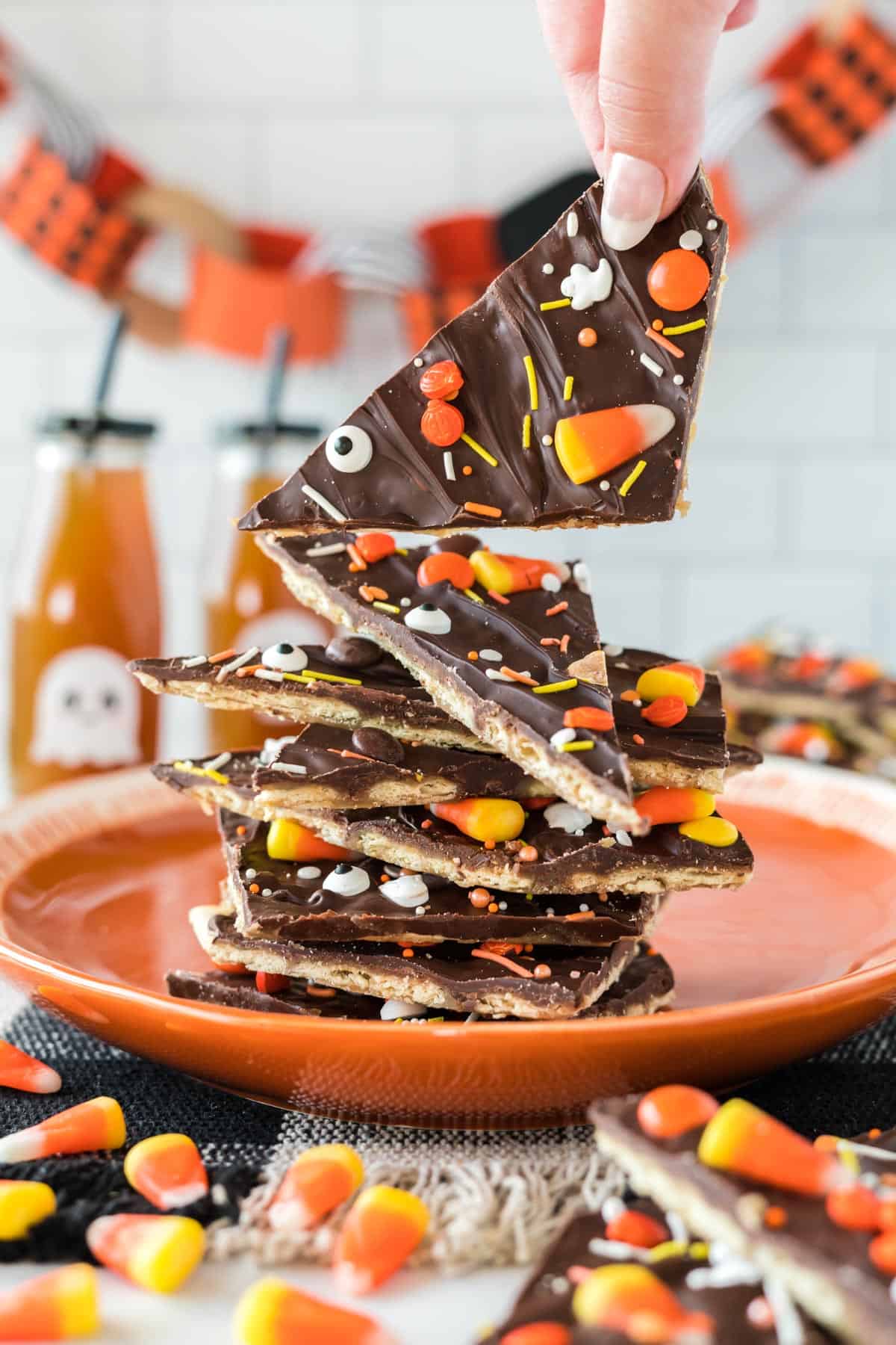 halloween crack candy pieces stacked on an orange plate