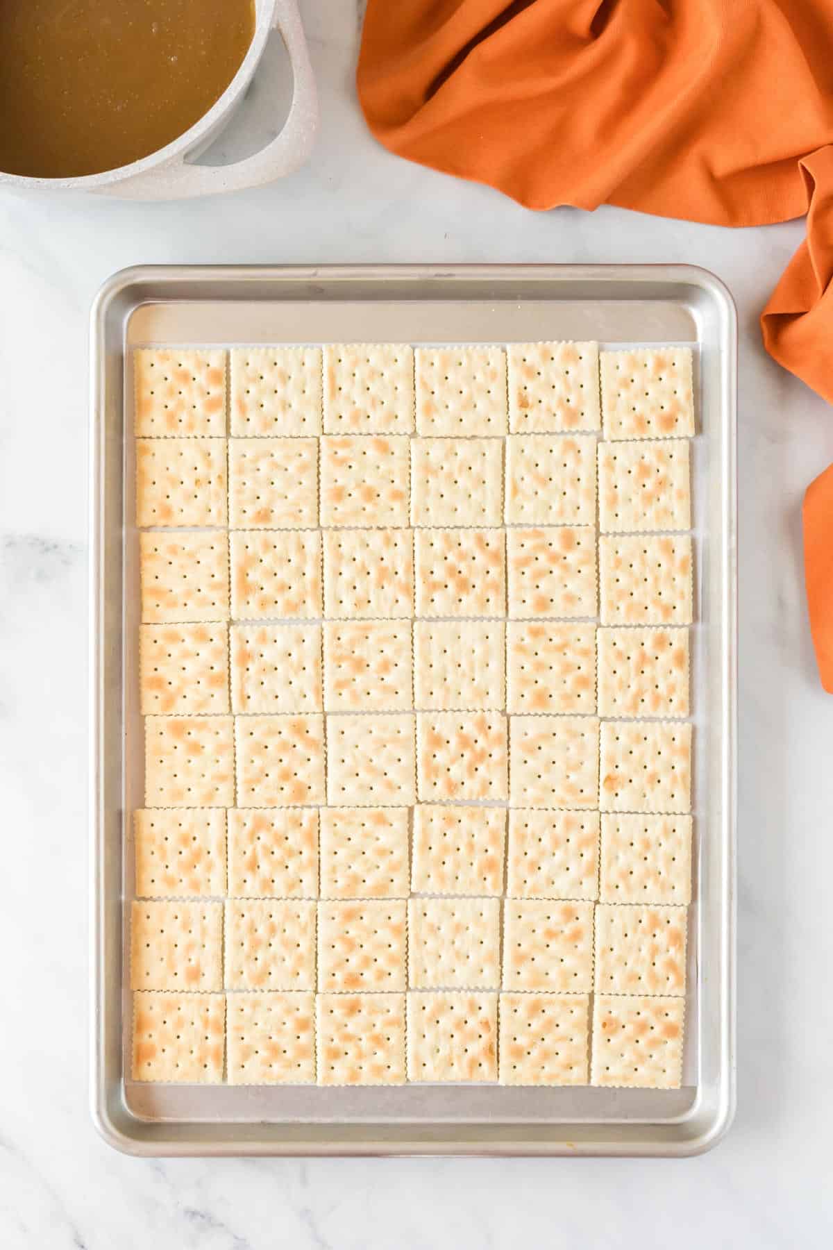 baking sheet lined with saltine crackers