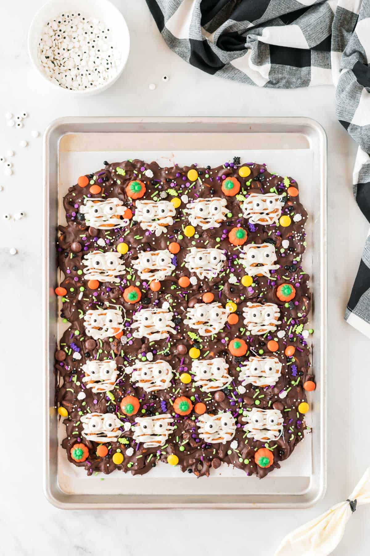 halloween bark with white chocolate drizzled over the pretzels