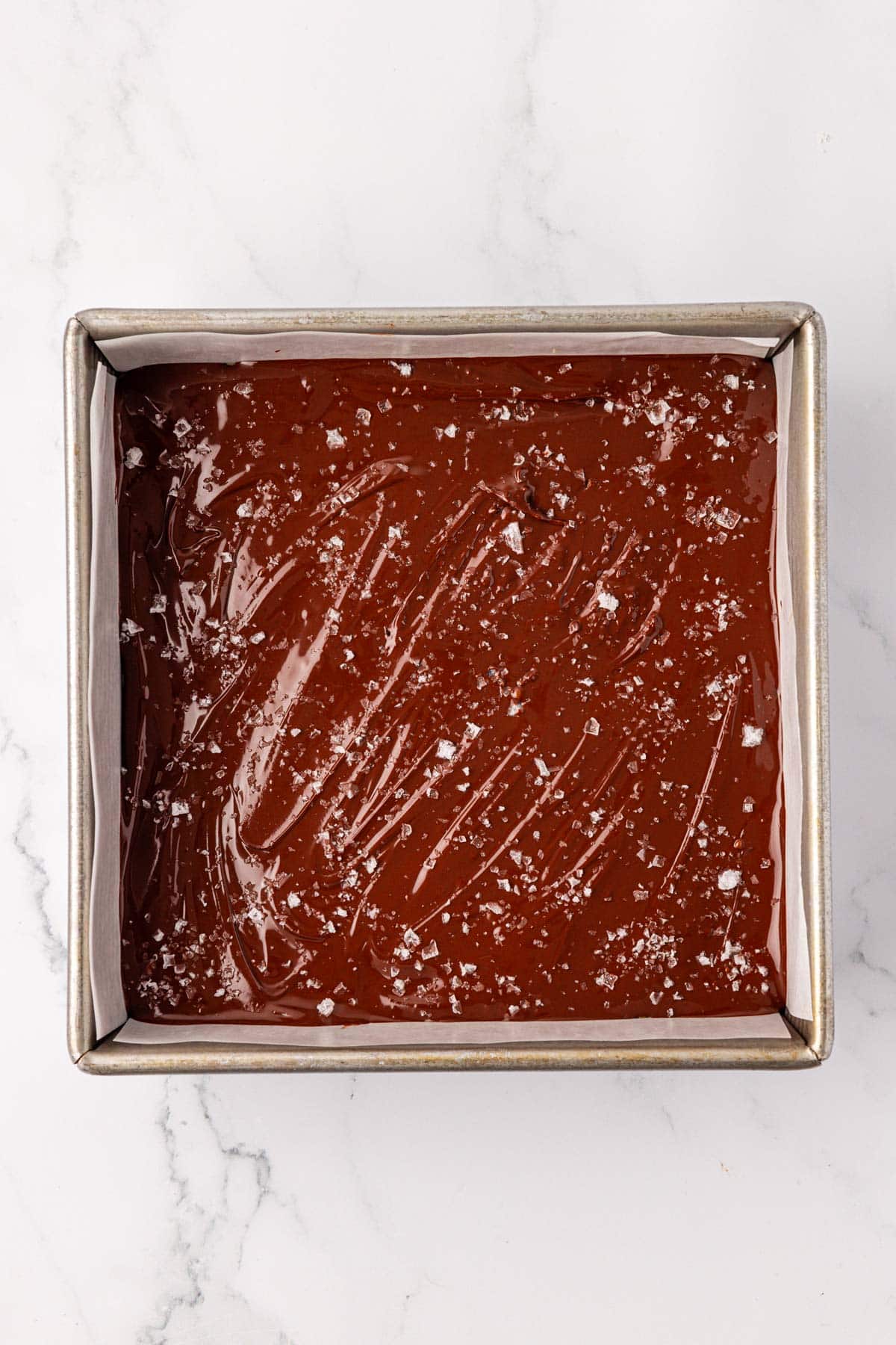 adding the sea salt flakes on top of the melted chocolate