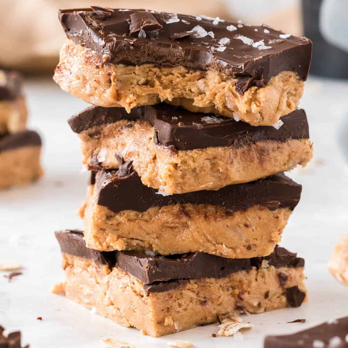 stacked protein bars with the top one missing a bite
