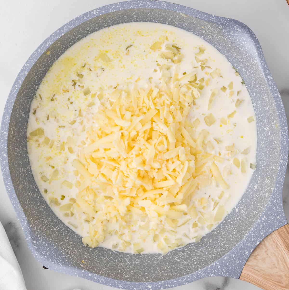 adding the cheese to the skillet