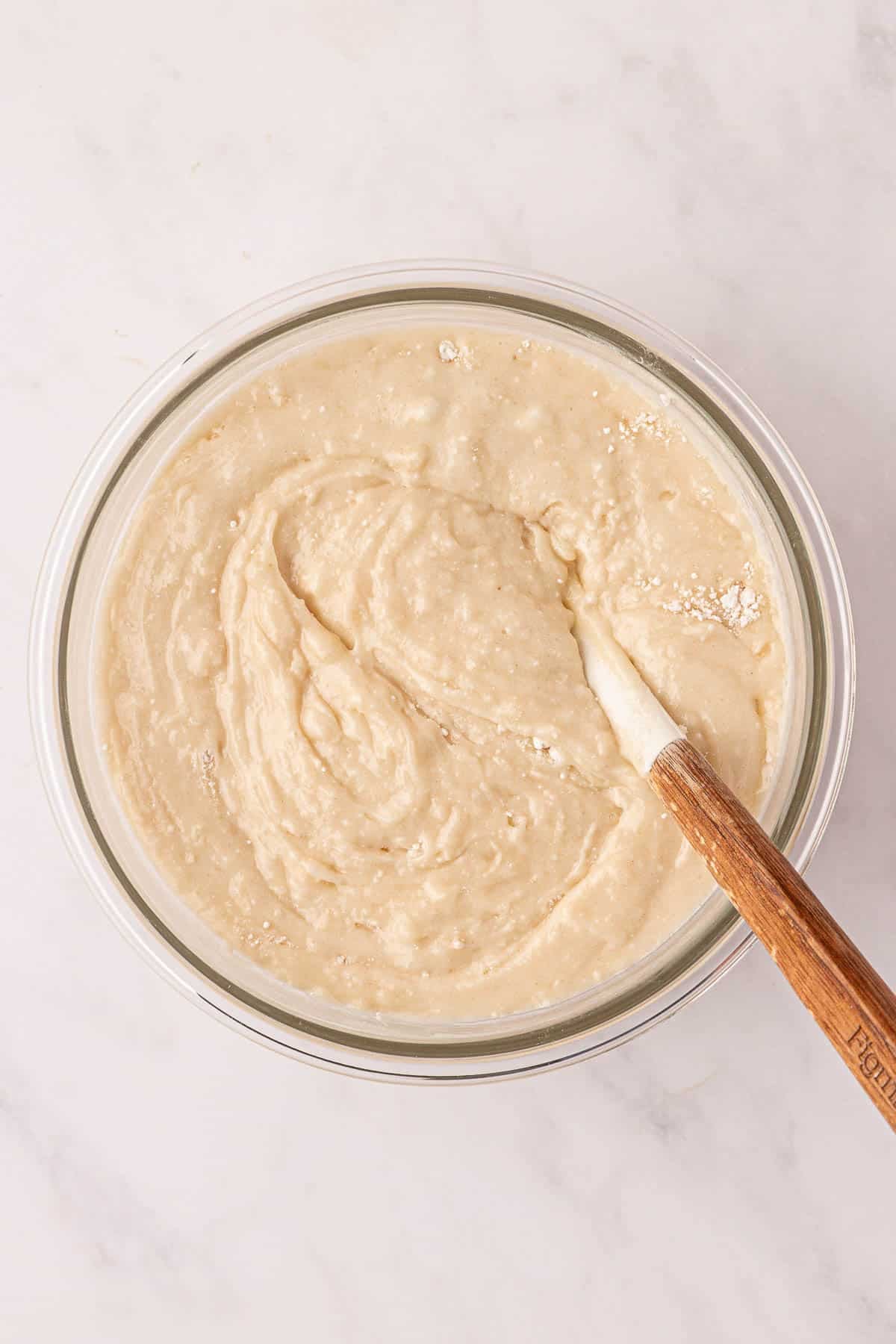 stirring the cobbler batter together in a mixing bowl