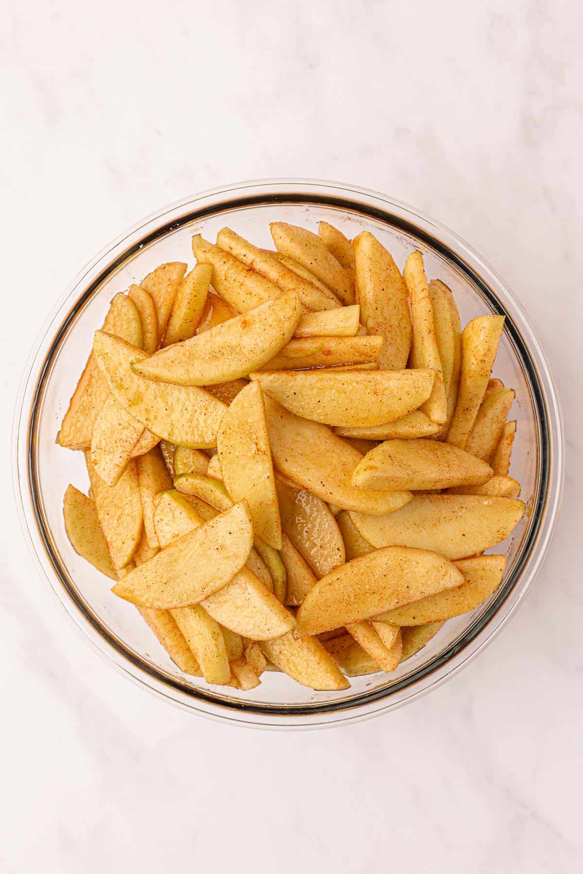 spiced apple slices in a mixing bowl