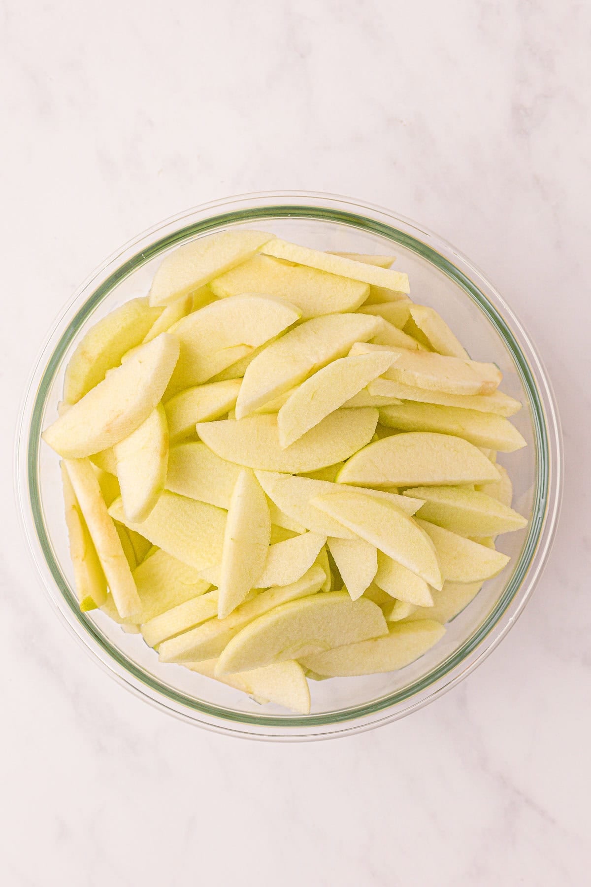 sliced apples in a mixing bowl