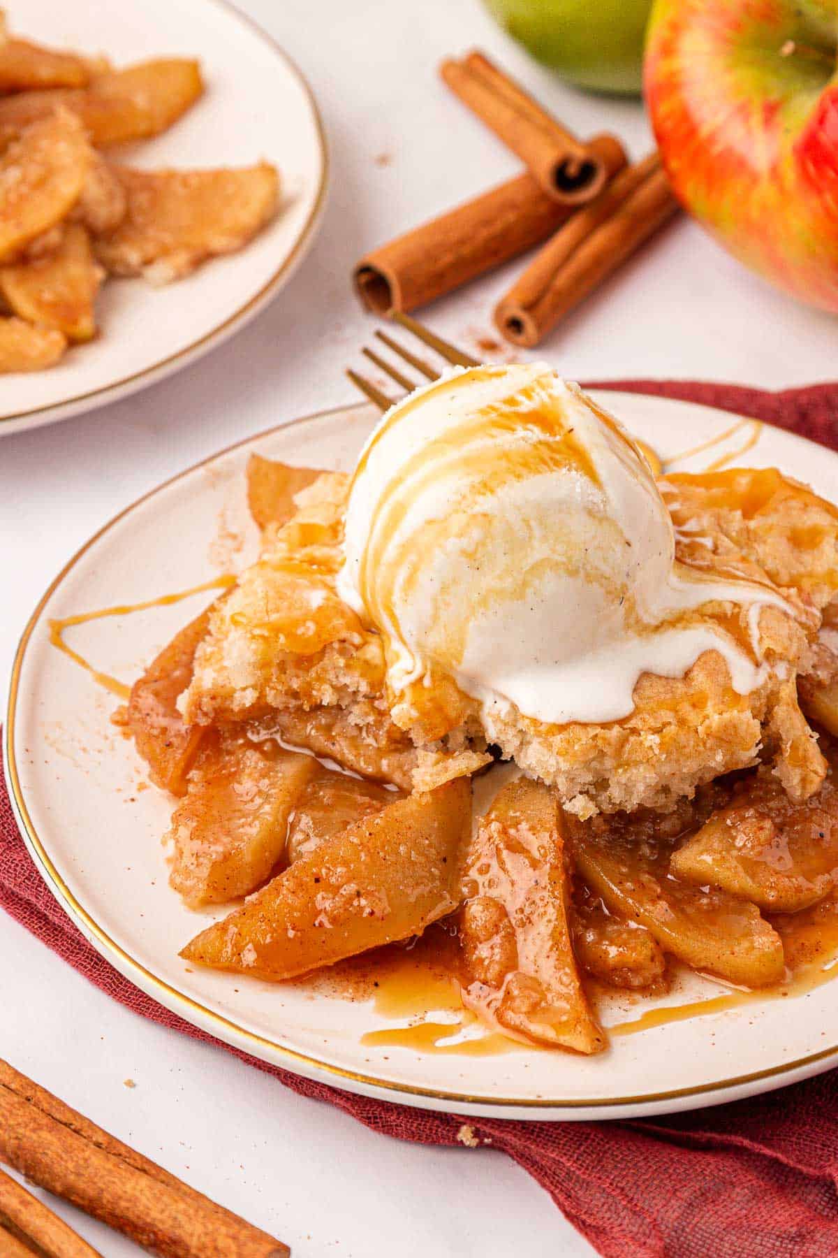 cake mix apple cobbler topped with vanilla ice cream and caramel sauce