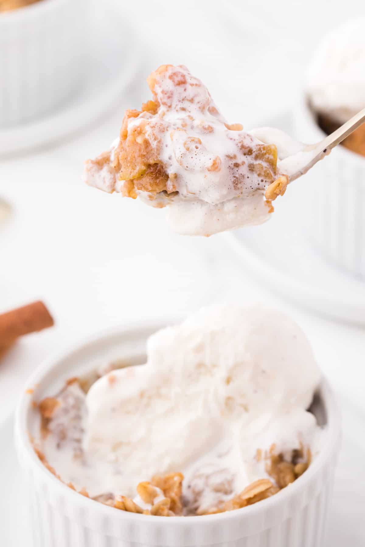 spoonful of apple crisp with ice cream