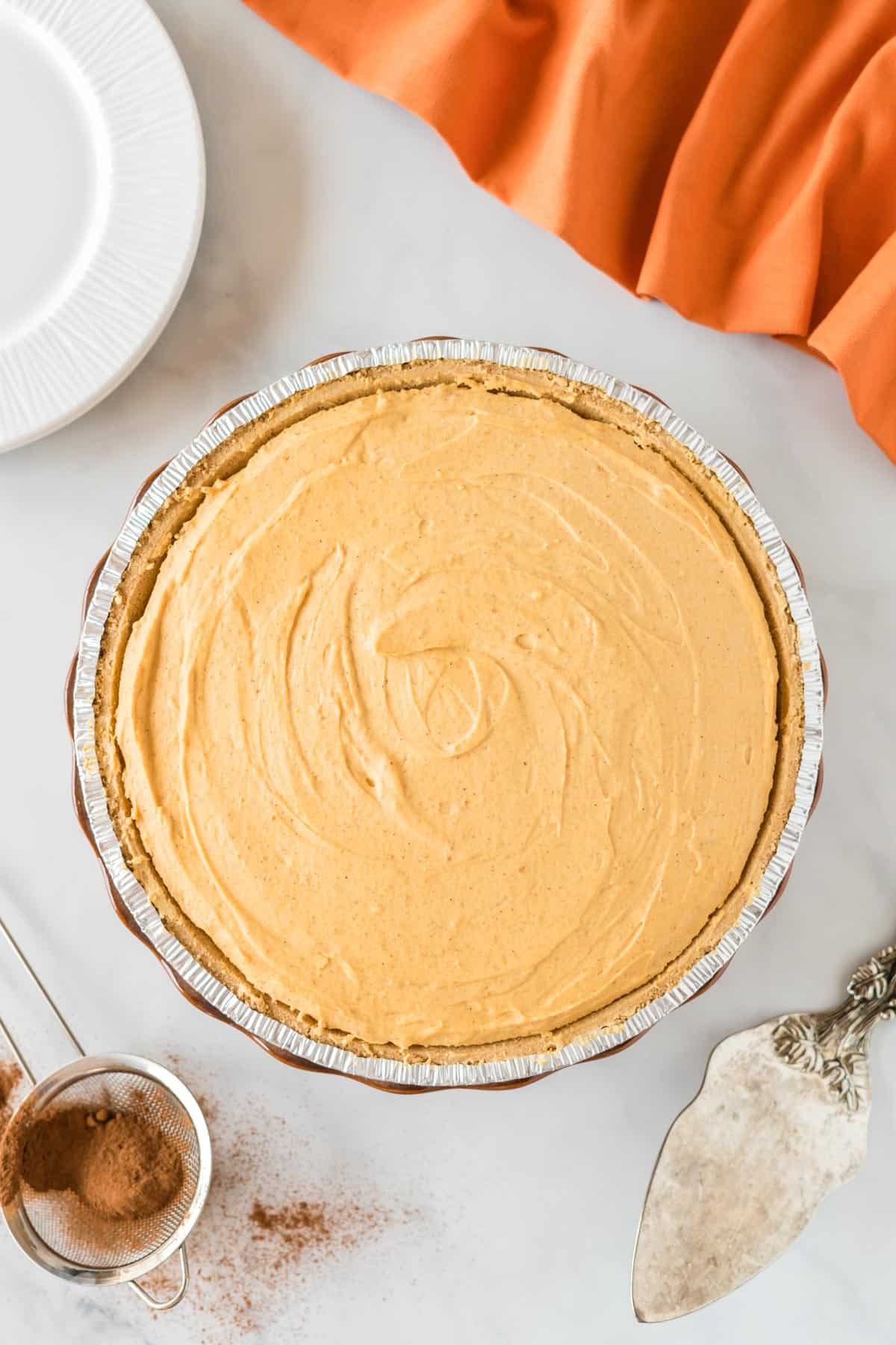 pumpkin pie filling smoothed out in the graham crust