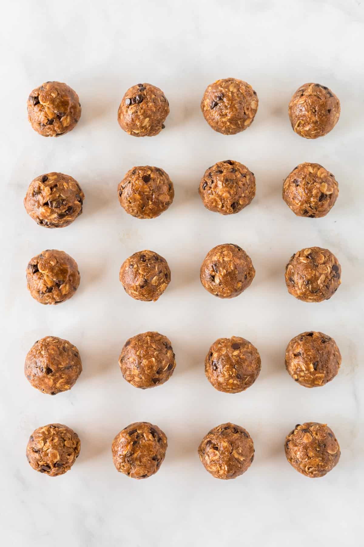 pumpkin protein balls lined up on a baking sheet