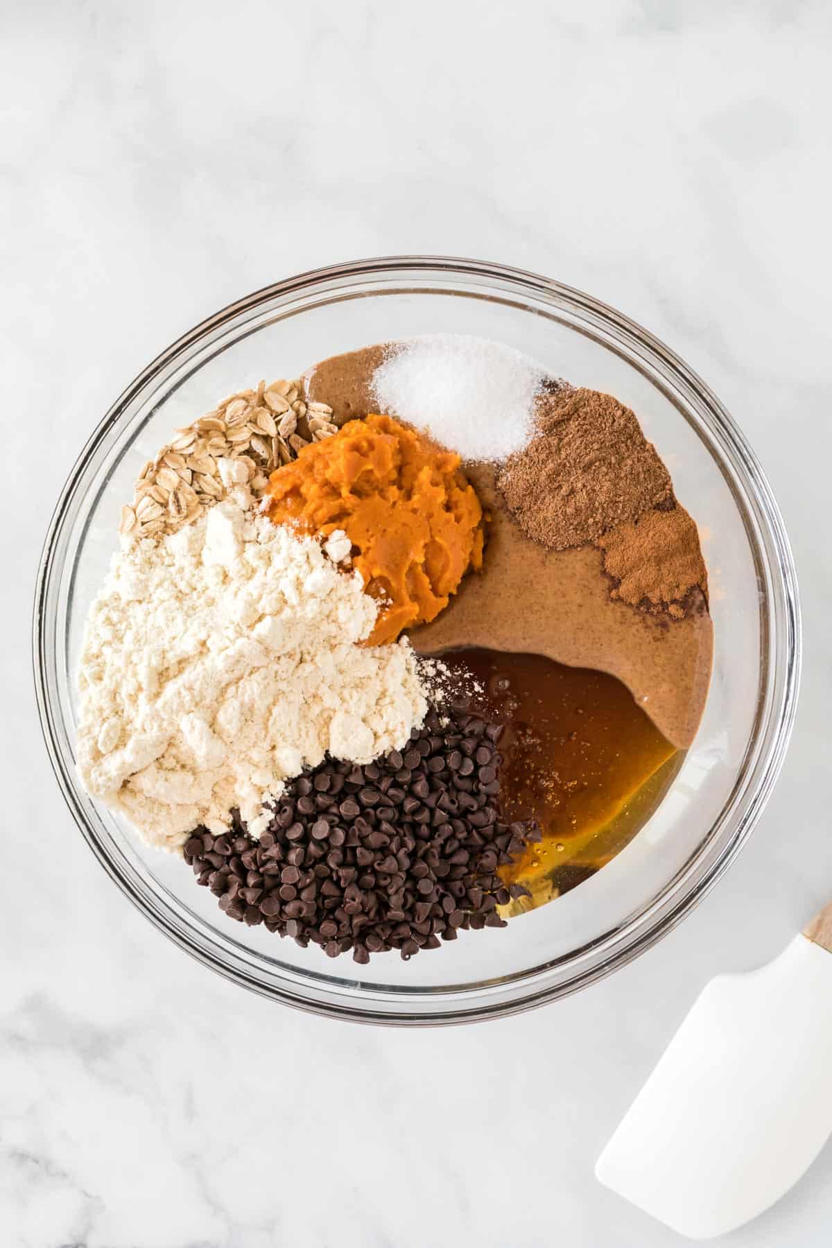 ingredients to make pumpkin protein balls in a mixing bowl