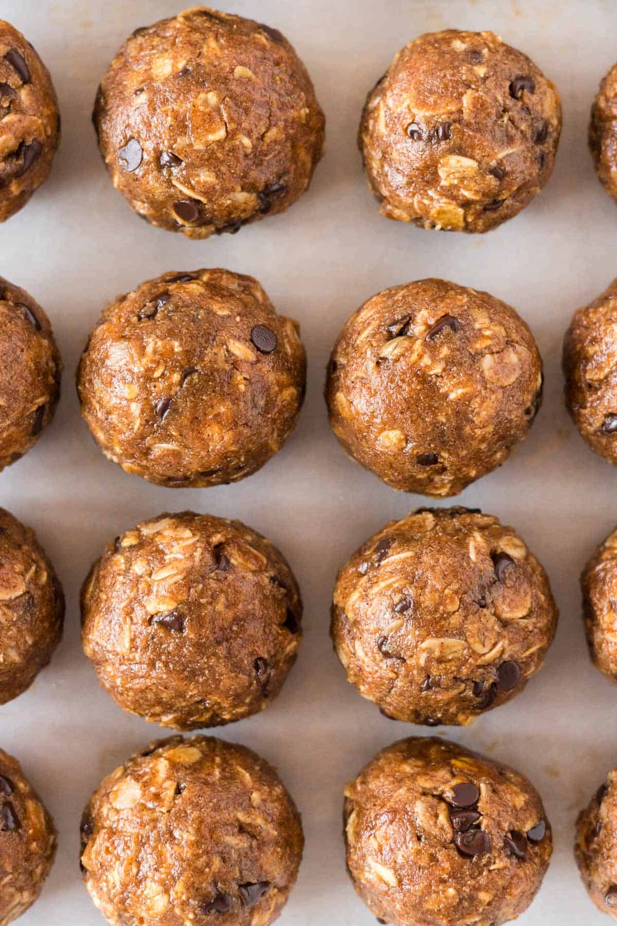 pumpkin protein balls lined up on a baking sheet