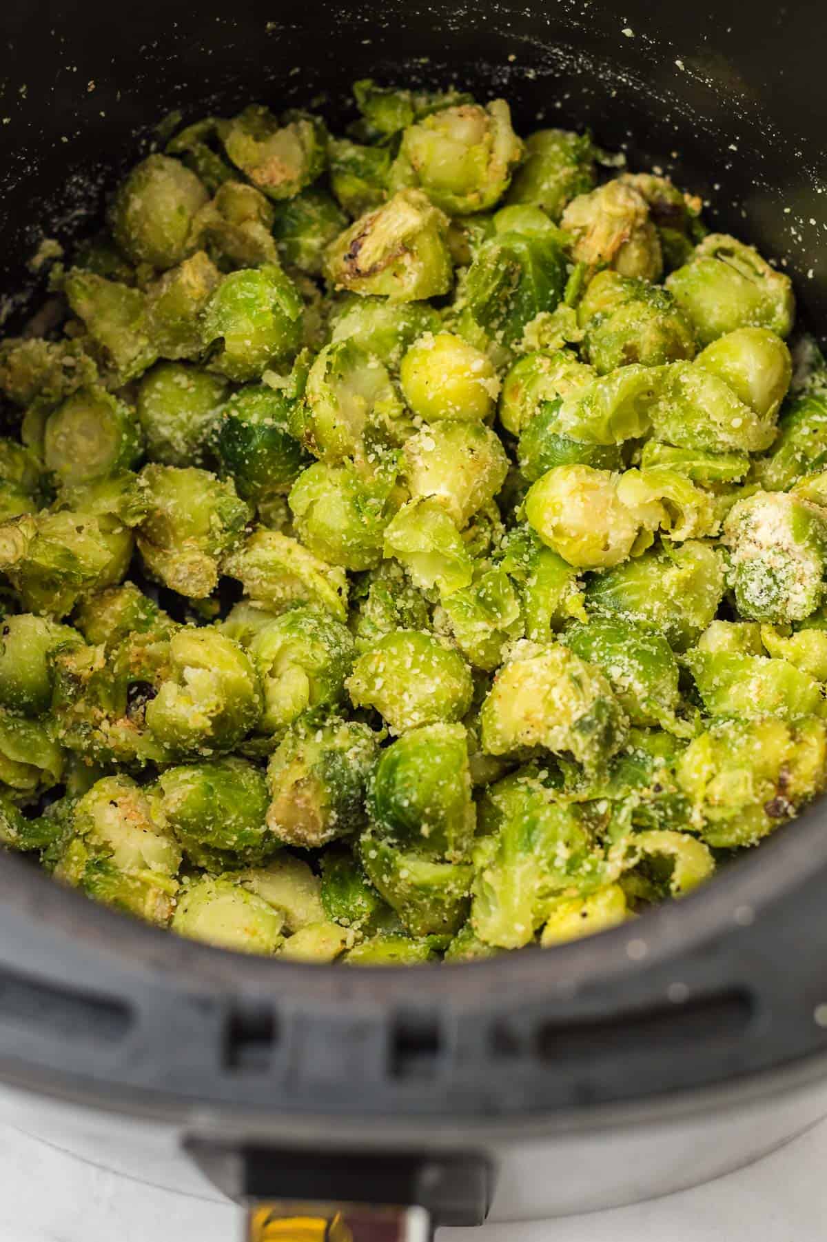 brussel sprouts cut up and topped with parmesan cheese