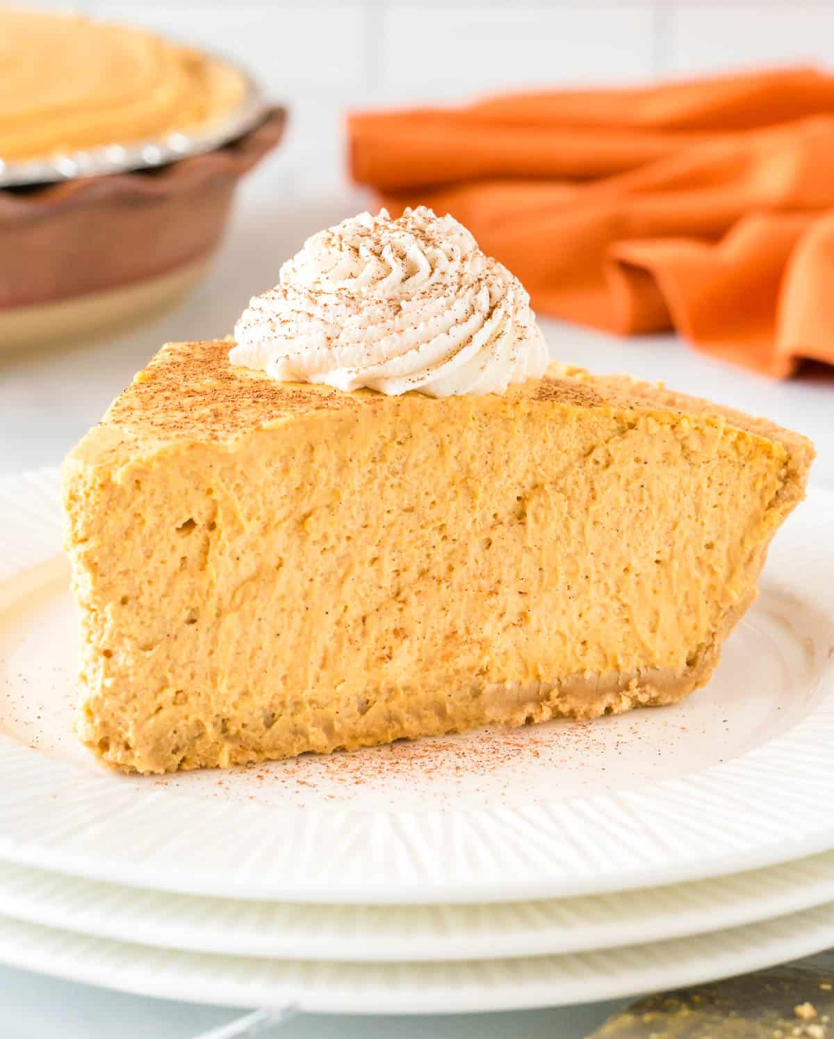 slice of pumpkin cream pie topped with whipped cream