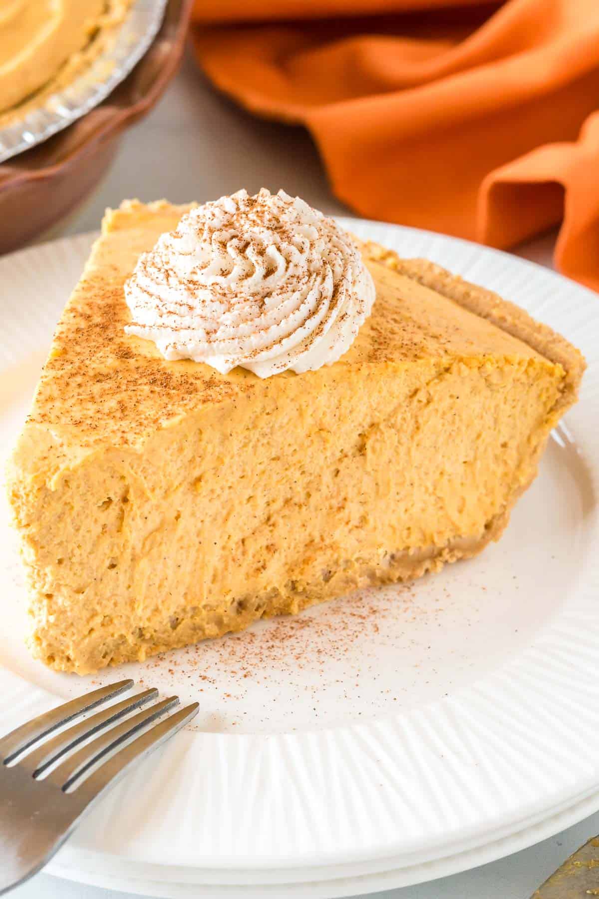 slice of pumpkin cream pie topped with whipped cream