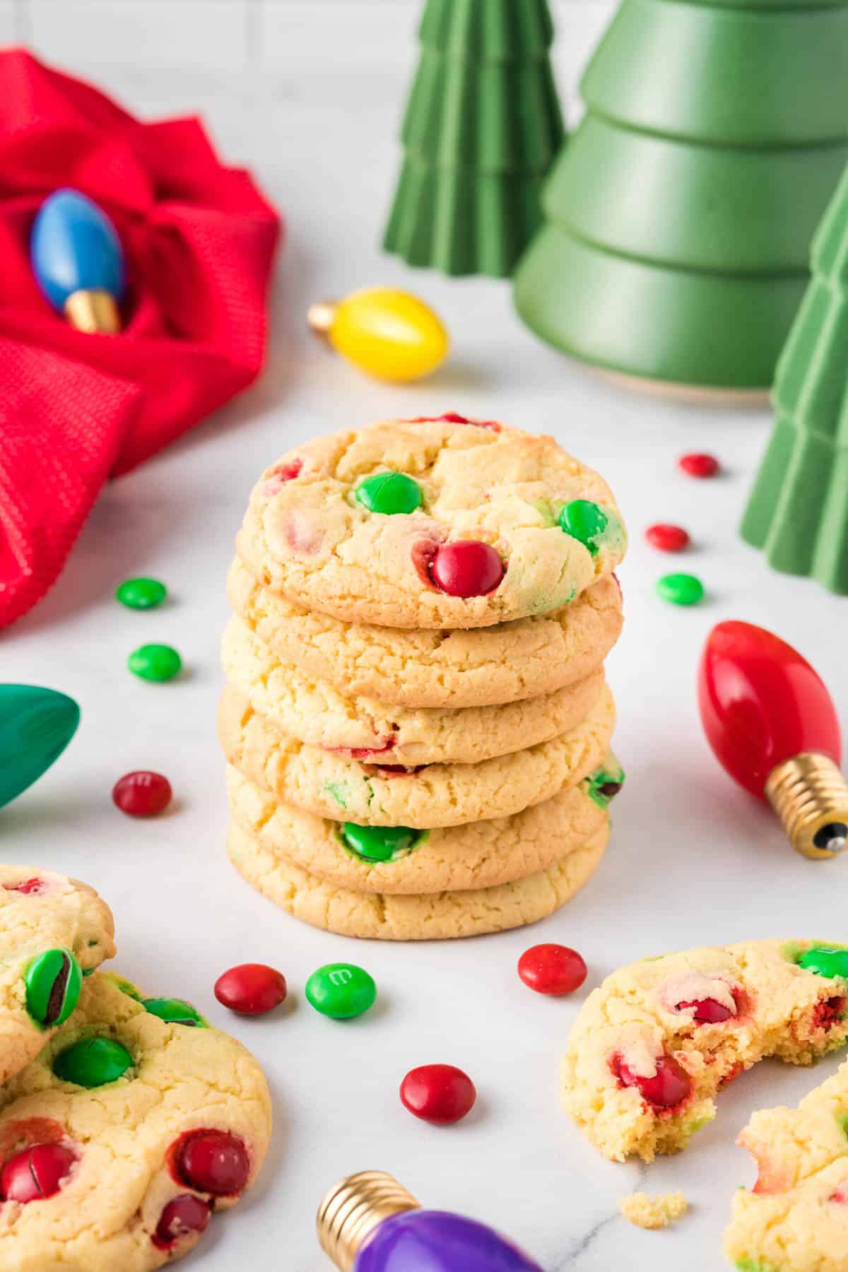 Christmas cookies stacked and surrounded by decorations