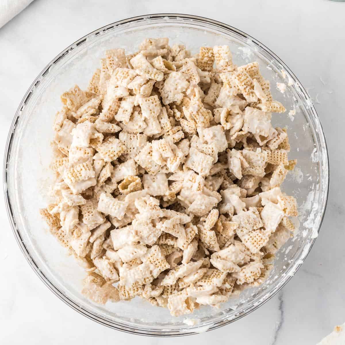 rice chex in a bowl coated in melted white chocolate
