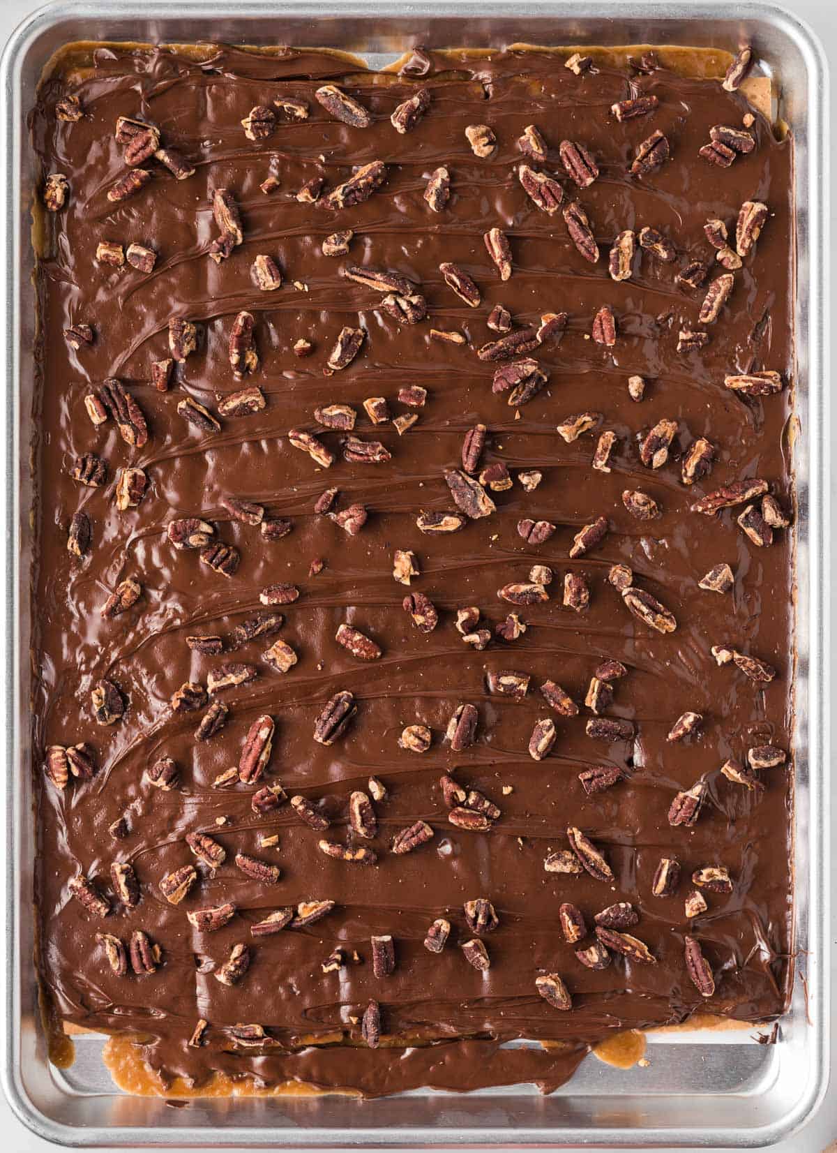 adding pecans to the melted chocolate