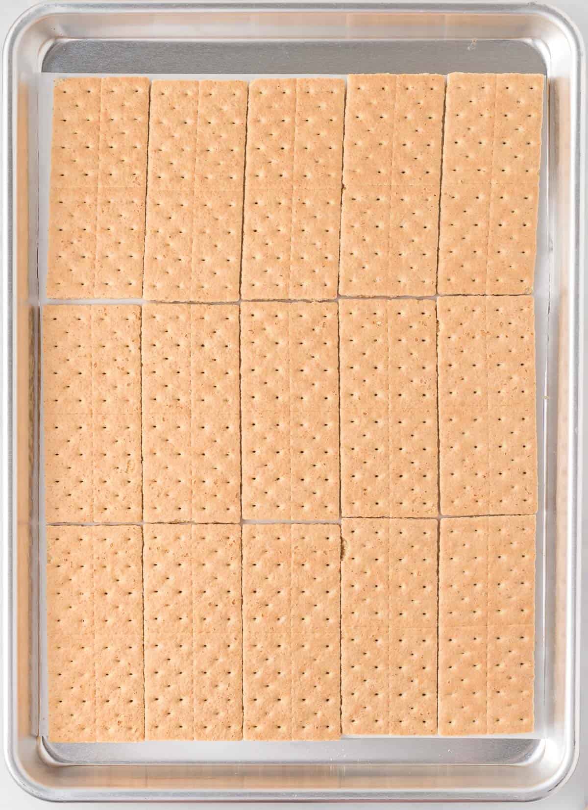 graham crackers lined up on a baking sheet